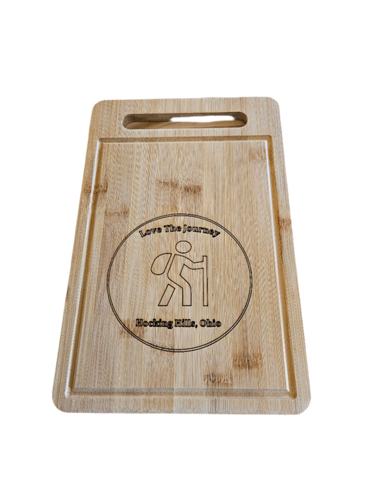 Wooden cutting board with engraved design on a wooden background