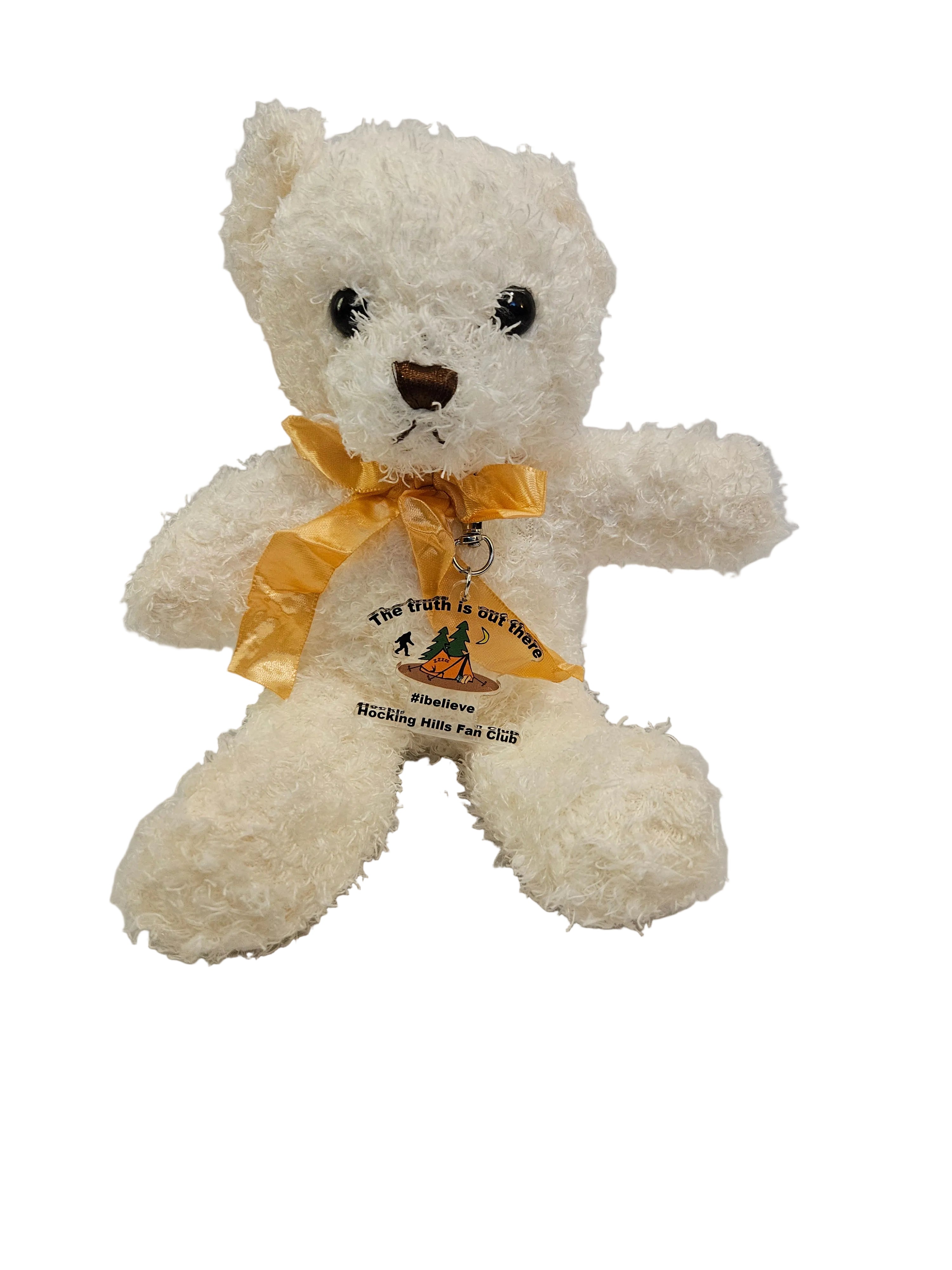 White teddy bear with a yellow bow on a light gray background