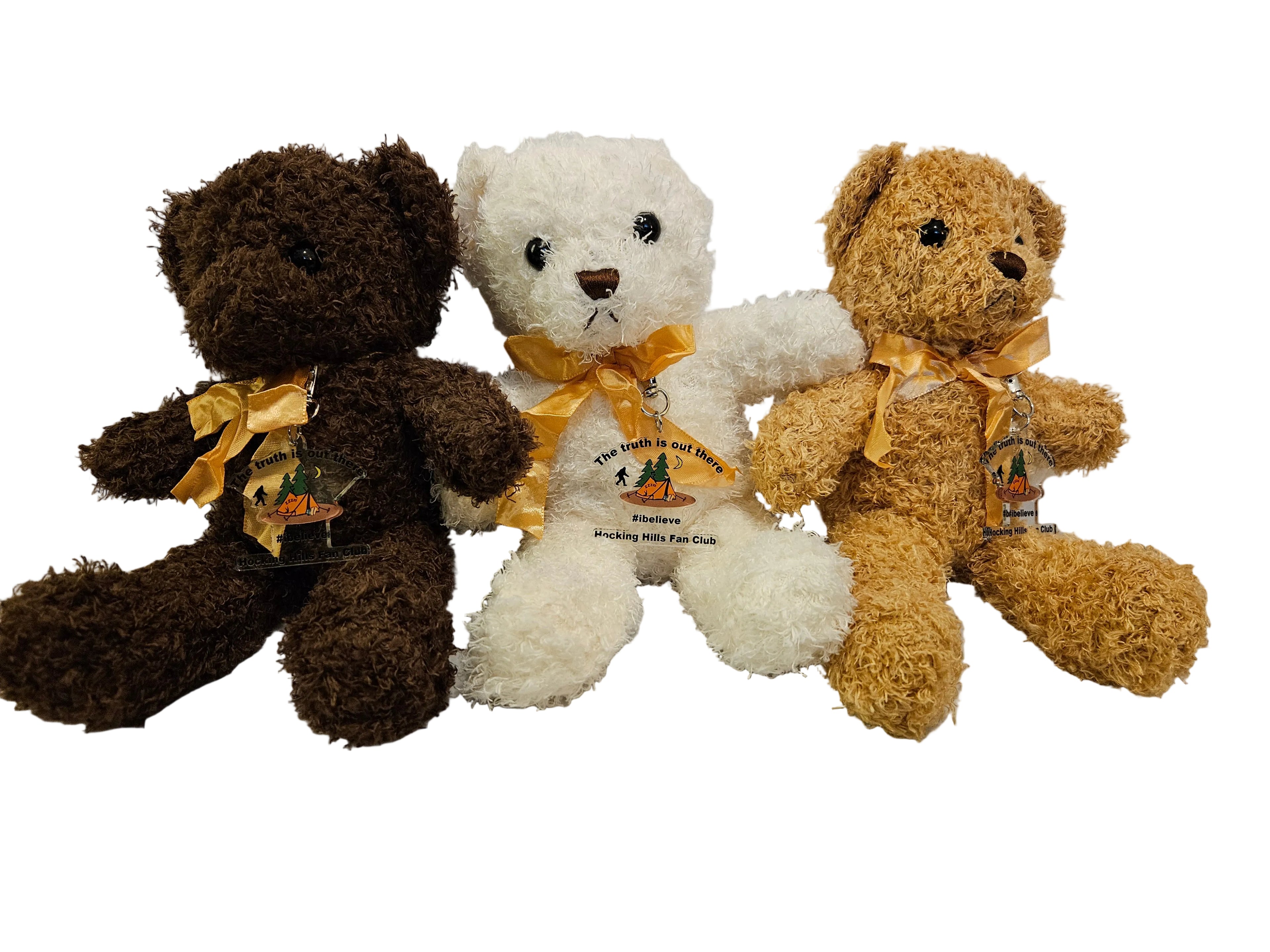 Three teddy bears in brown, white, and beige with yellow ribbons on a light gray background.