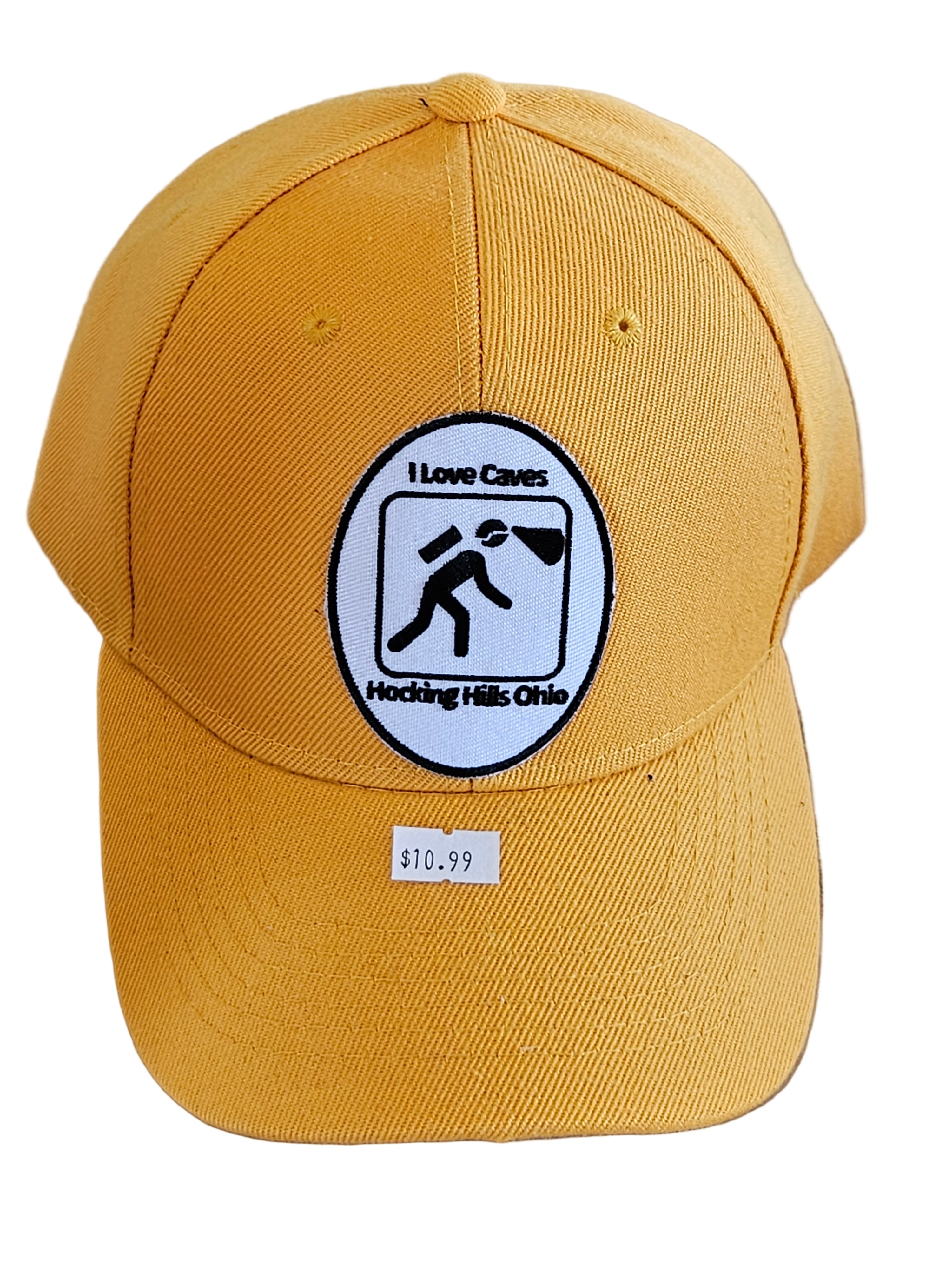 Yellow cap with a black and white logo on a wooden surface