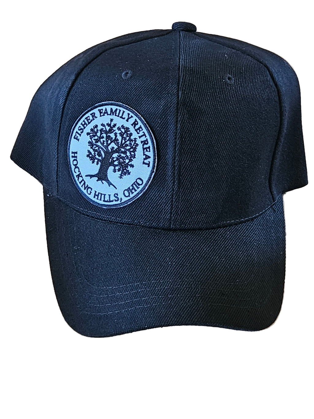 Navy blue cap with a circular logo on a wooden surface