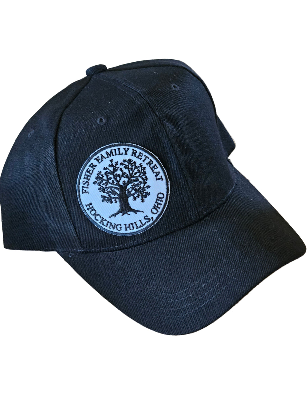 Black cap with a white logo on a wooden surface