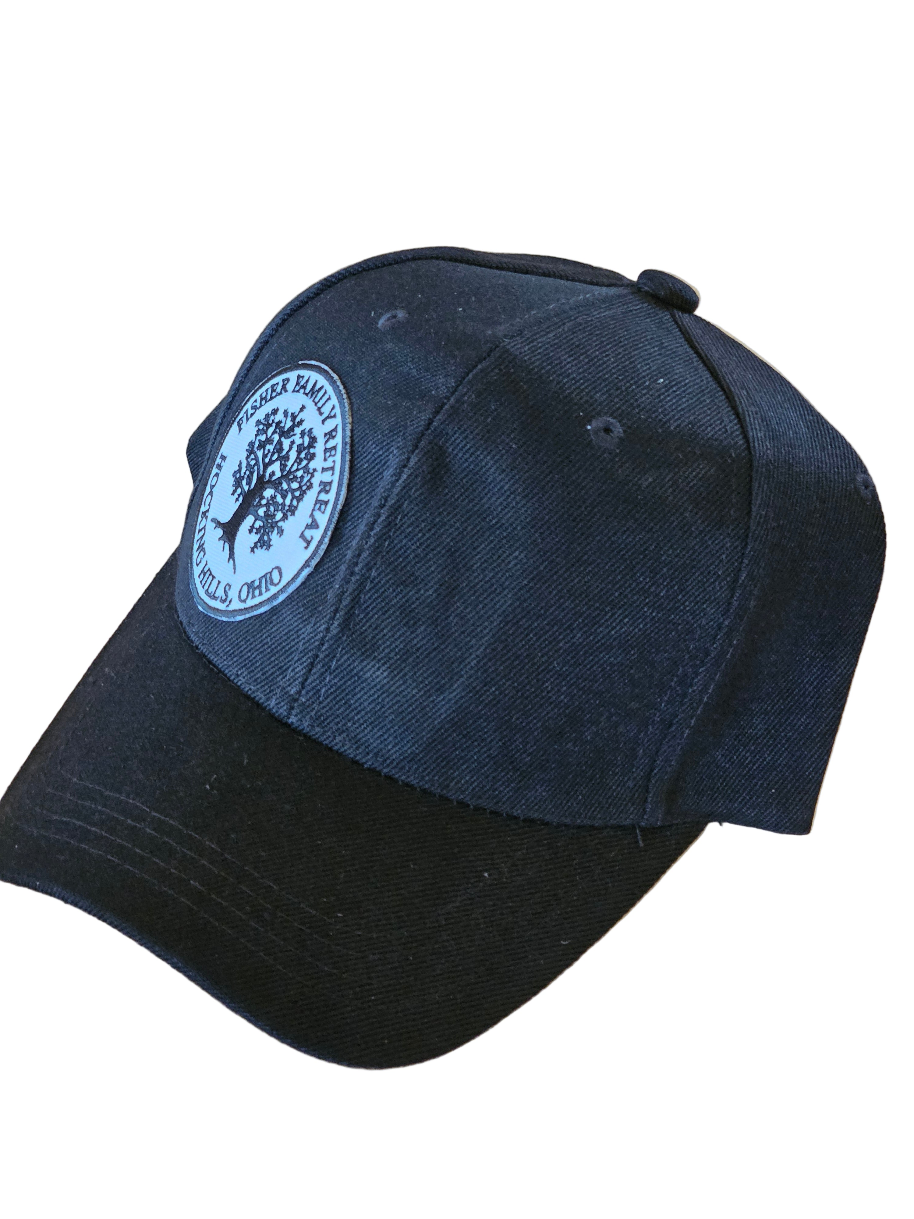 Black cap with a logo on a wooden surface