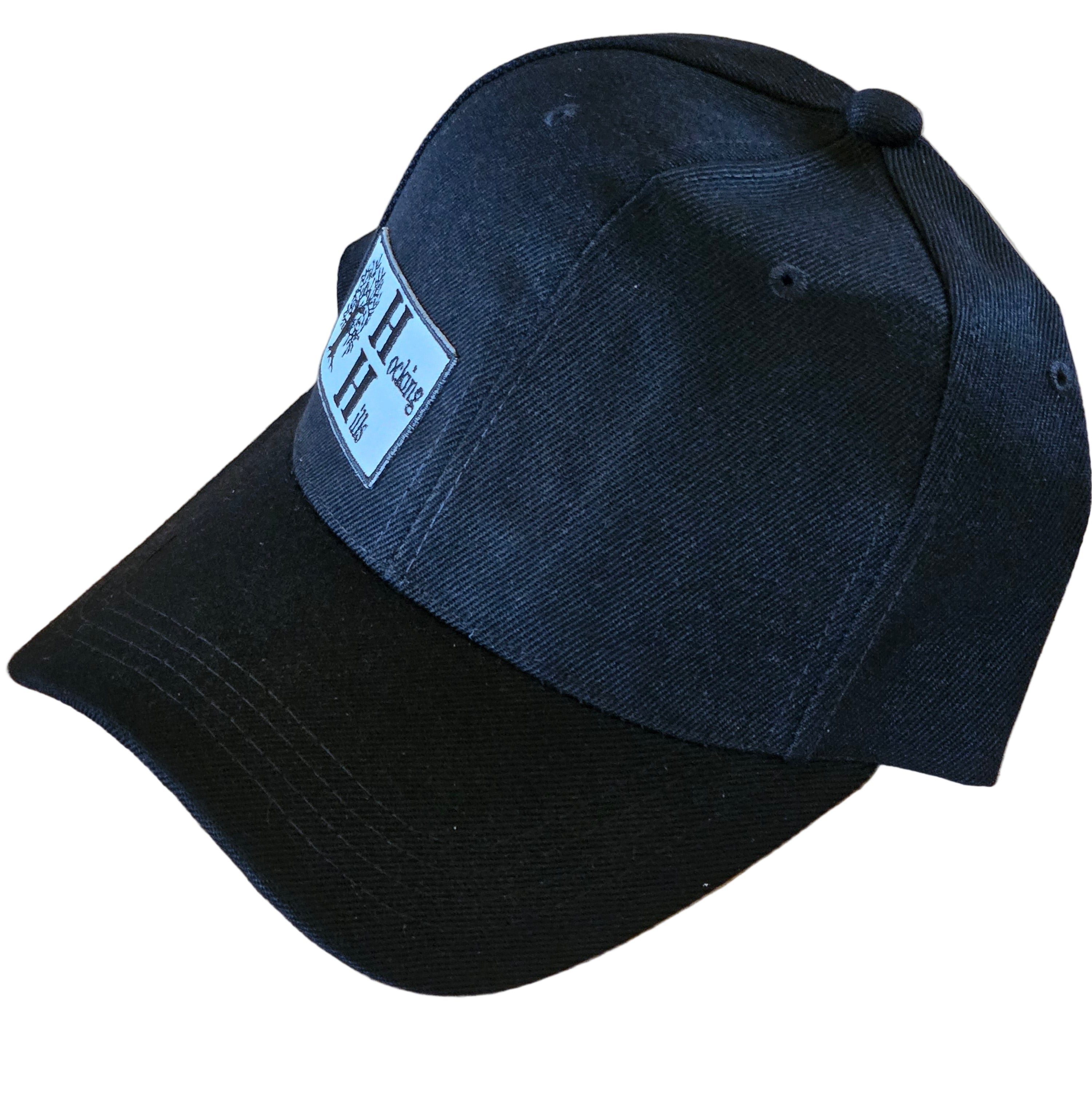 Black cap with a visible brand label on a white surface