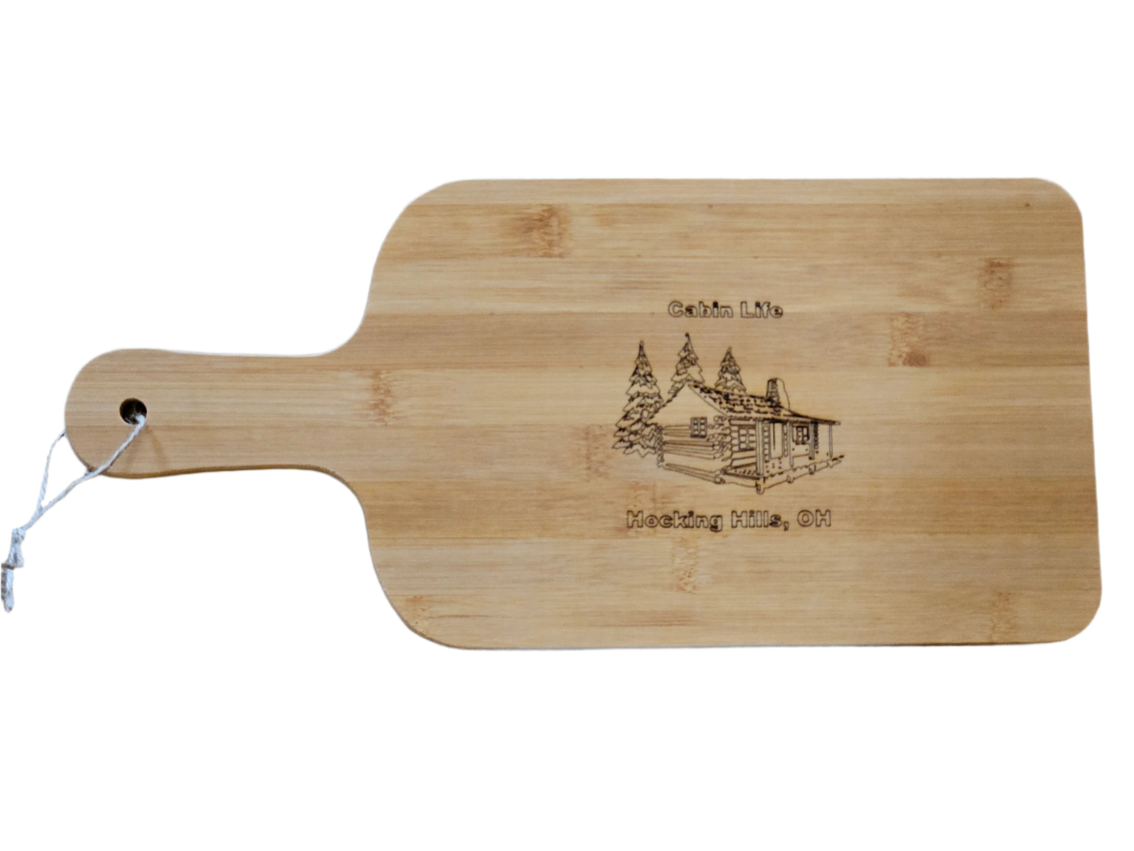 Wooden cutting board with engraved design and text on a gray surface