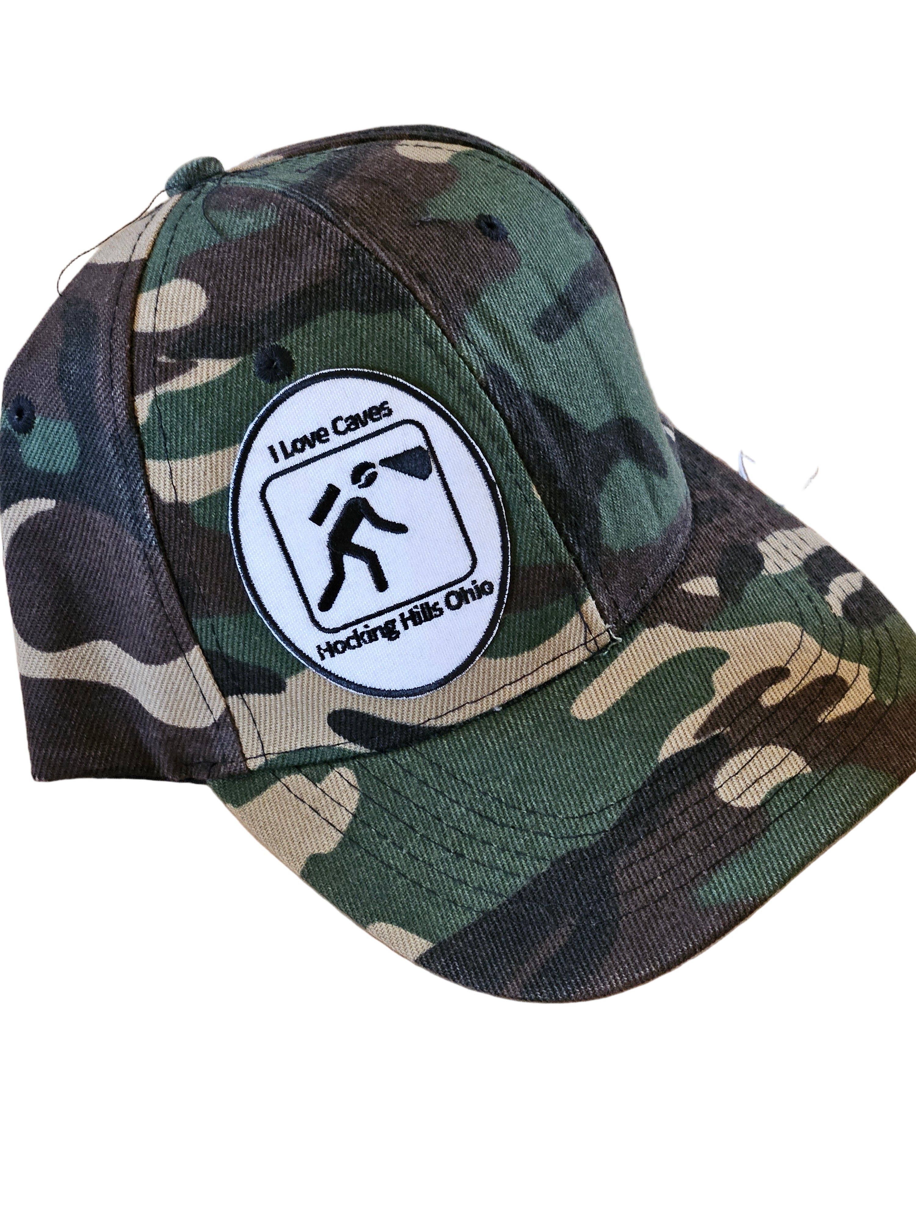 Camouflage cap with a logo on a wooden surface