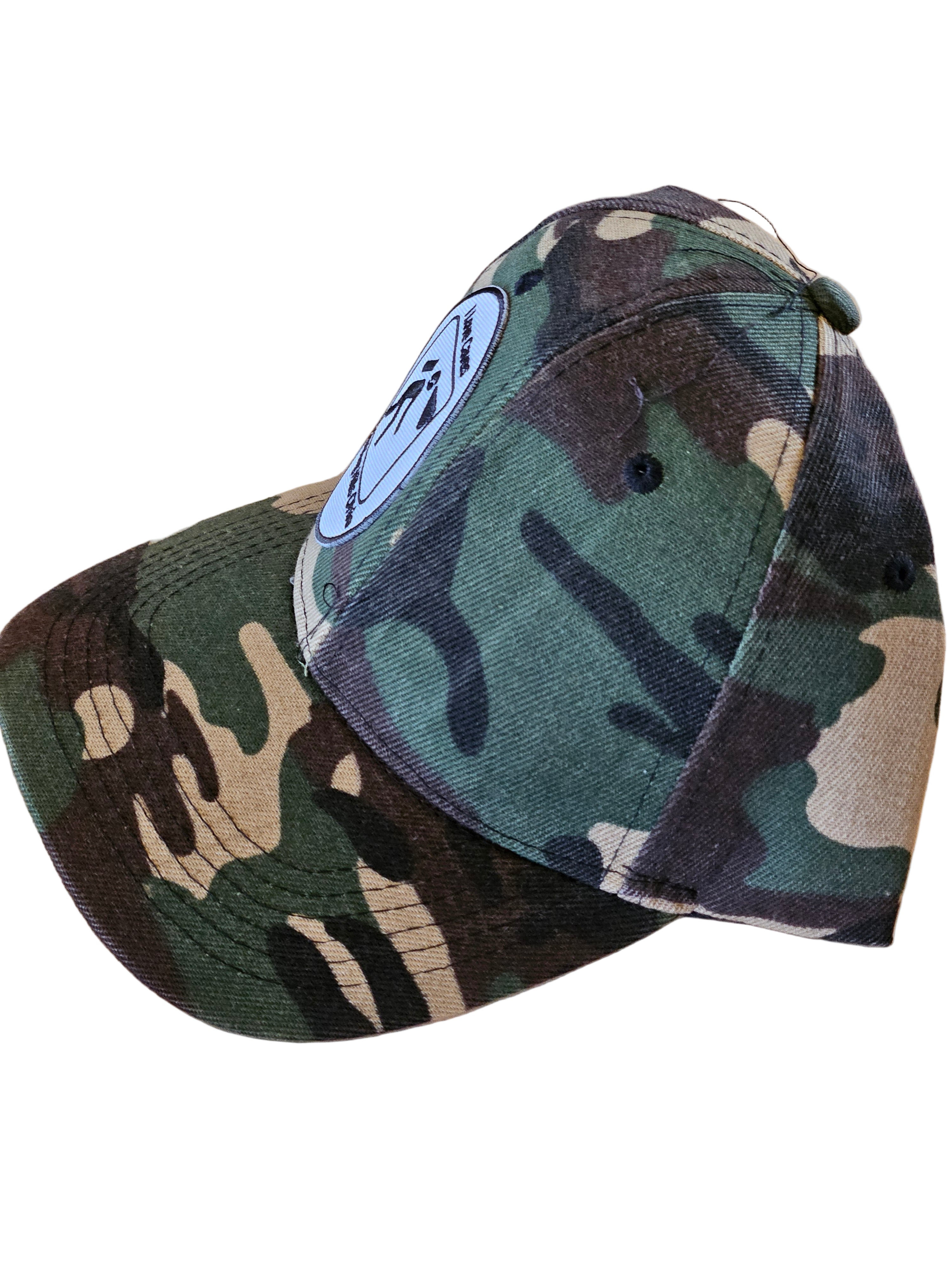 Two camouflage baseball caps on a wooden surface