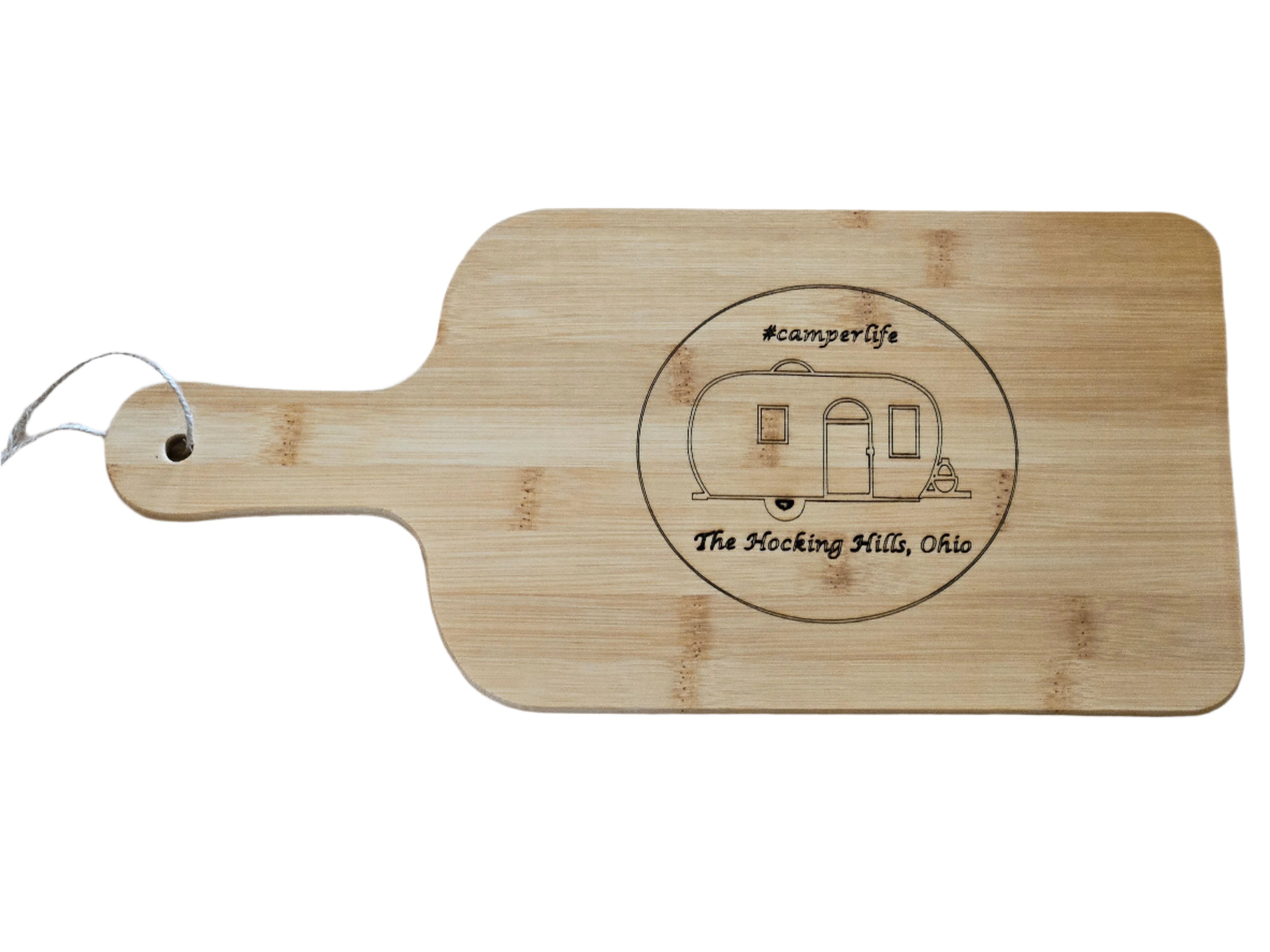 Wooden cutting board with engraved design and text on a wooden surface