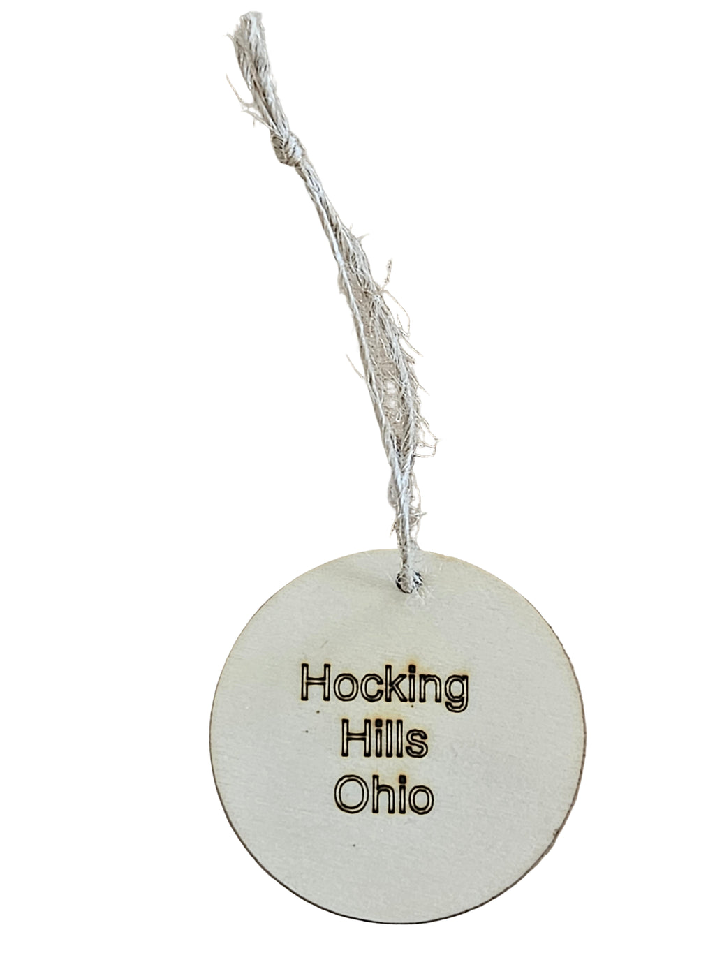 Round white tag with 'Hocking Hills Ohio' text on a white surface