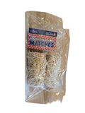 Pack of matches in a clear plastic bag on a wooden surface