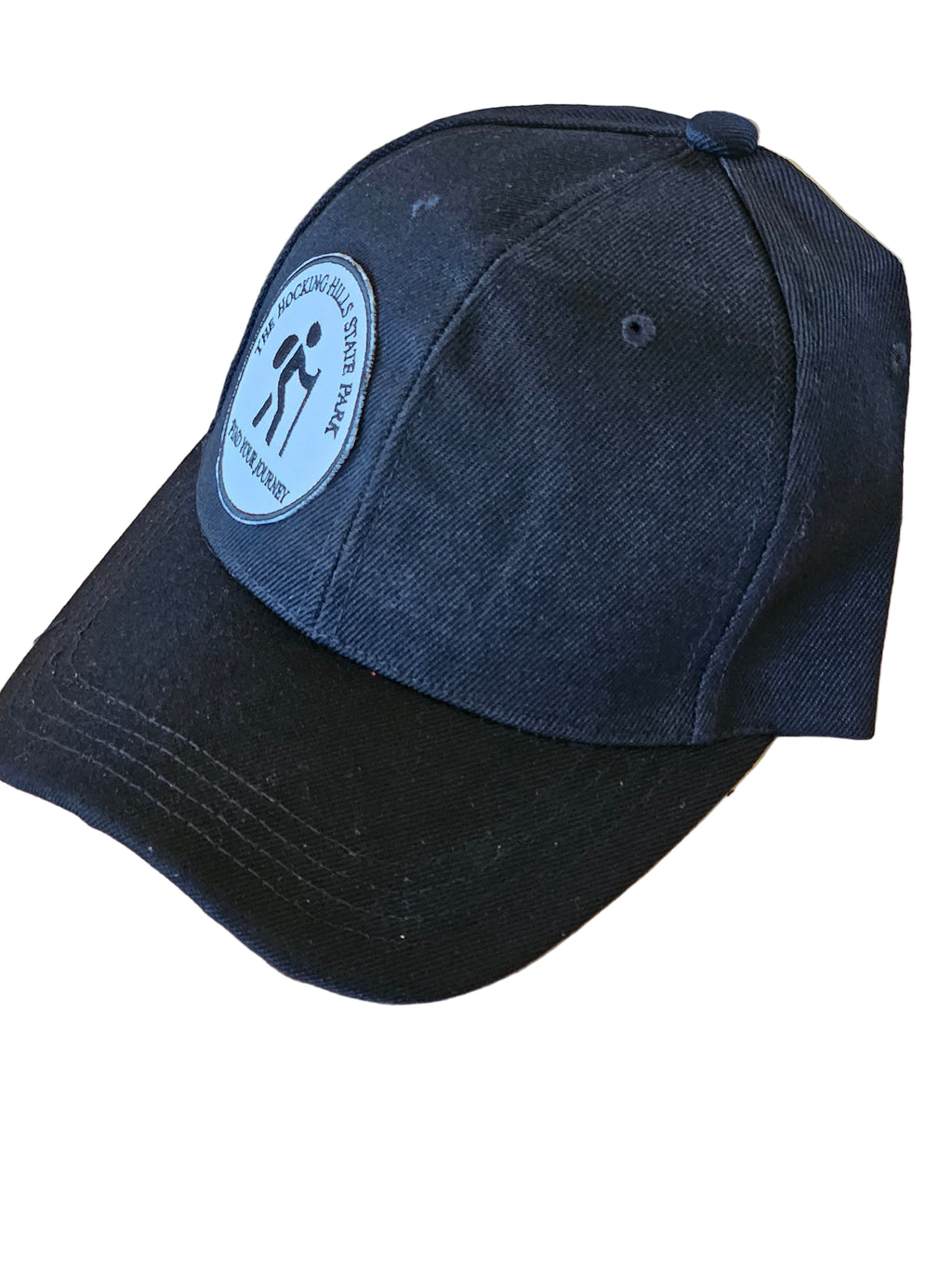 Black cap with a logo on a wooden surface