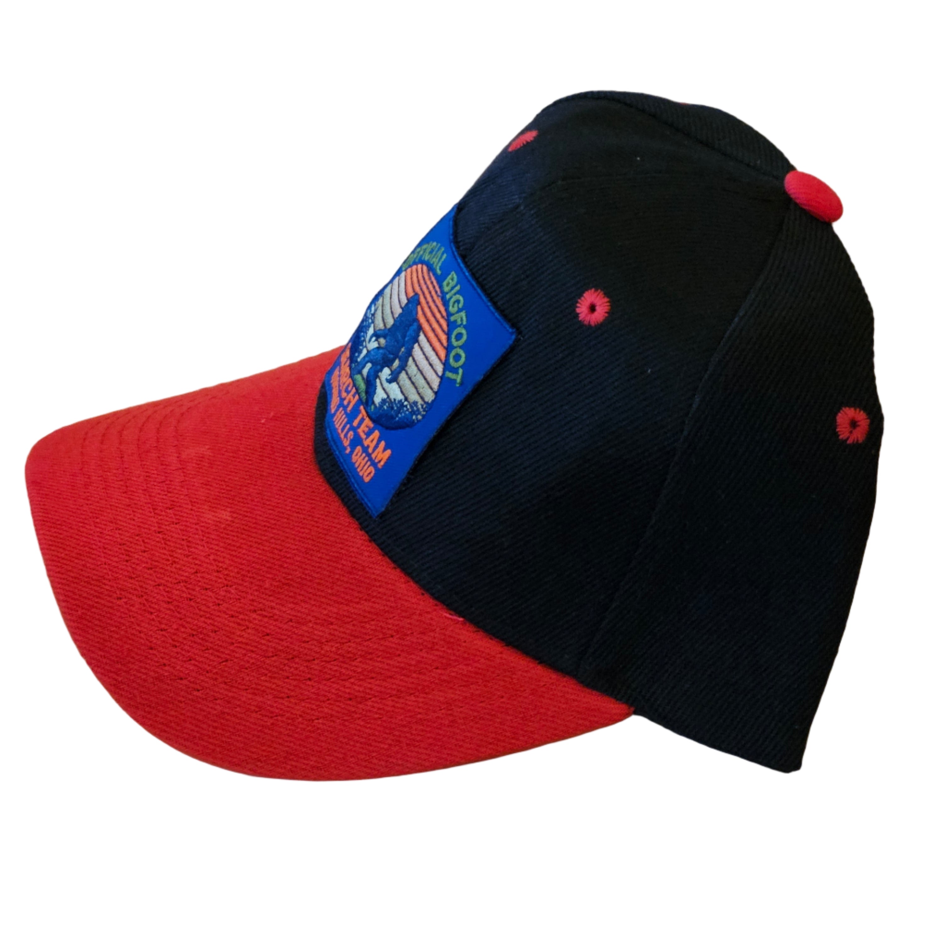 Black and red cap with a visible brand label on a white surface