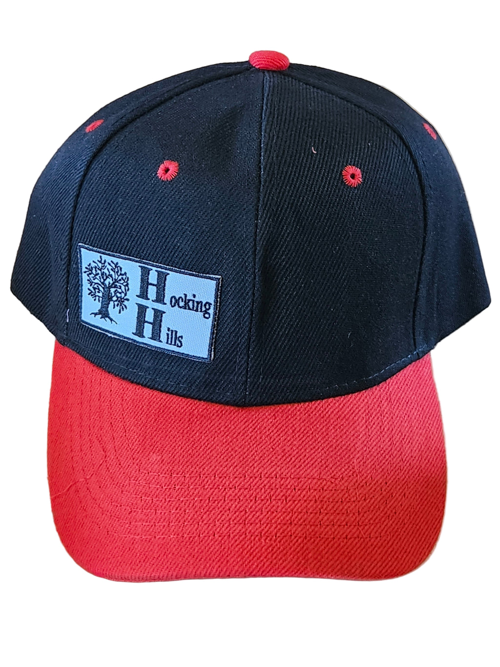 Black and red cap with a visible brand logo on a wooden surface