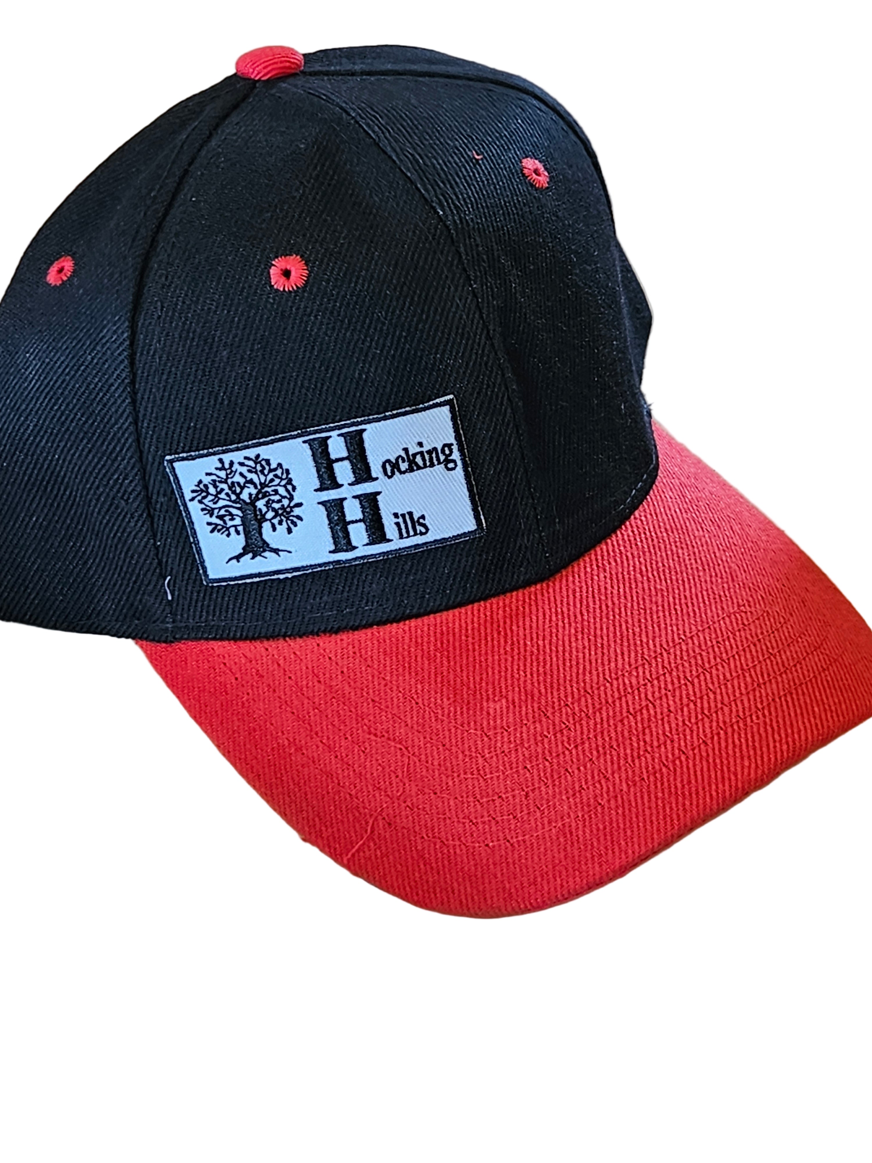 Black and red cap with a logo on a white surface