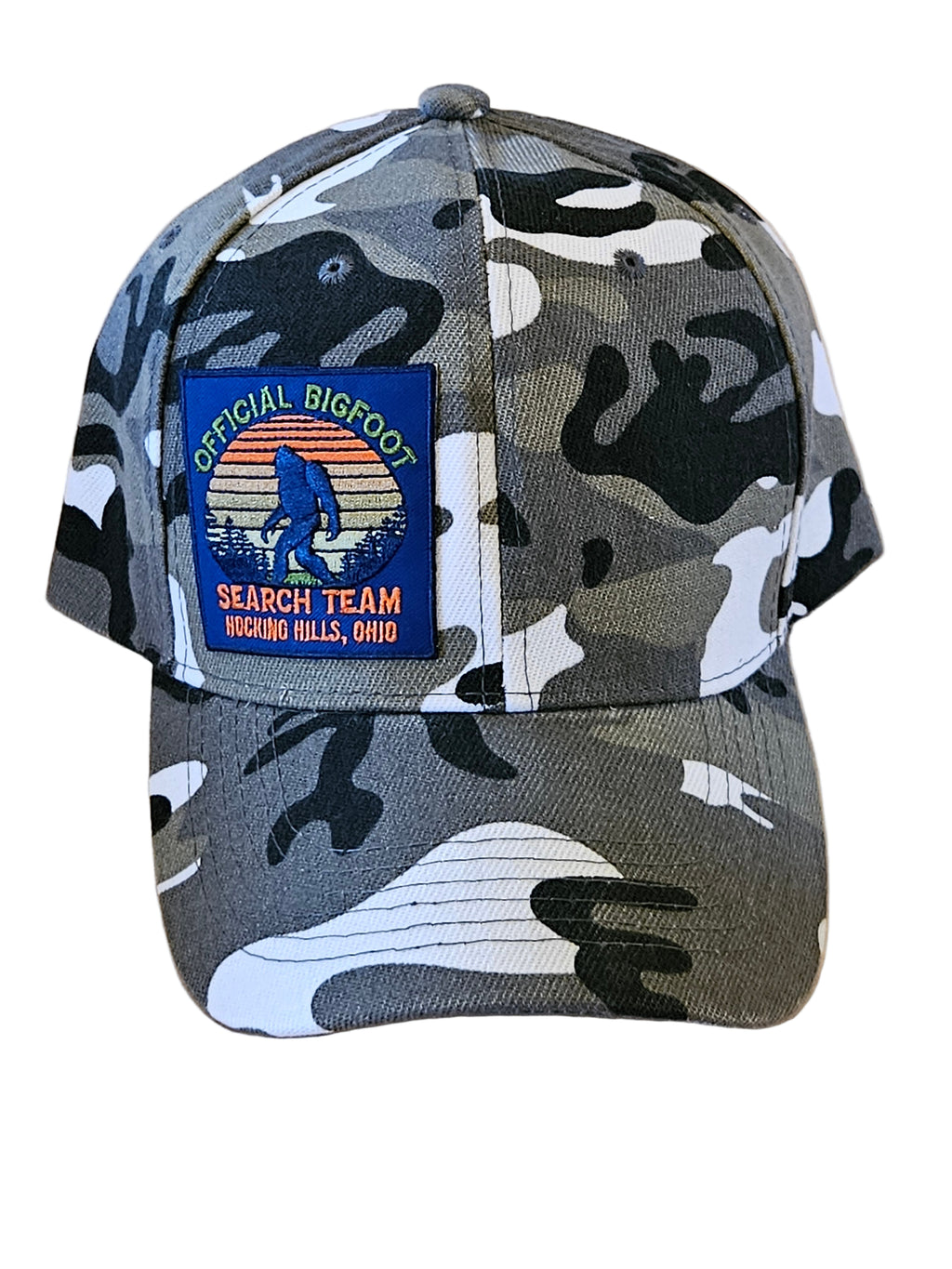 Camouflage-patterned cap with a logo on a wooden surface