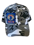 Camouflage-patterned cap with a logo on a wooden surface