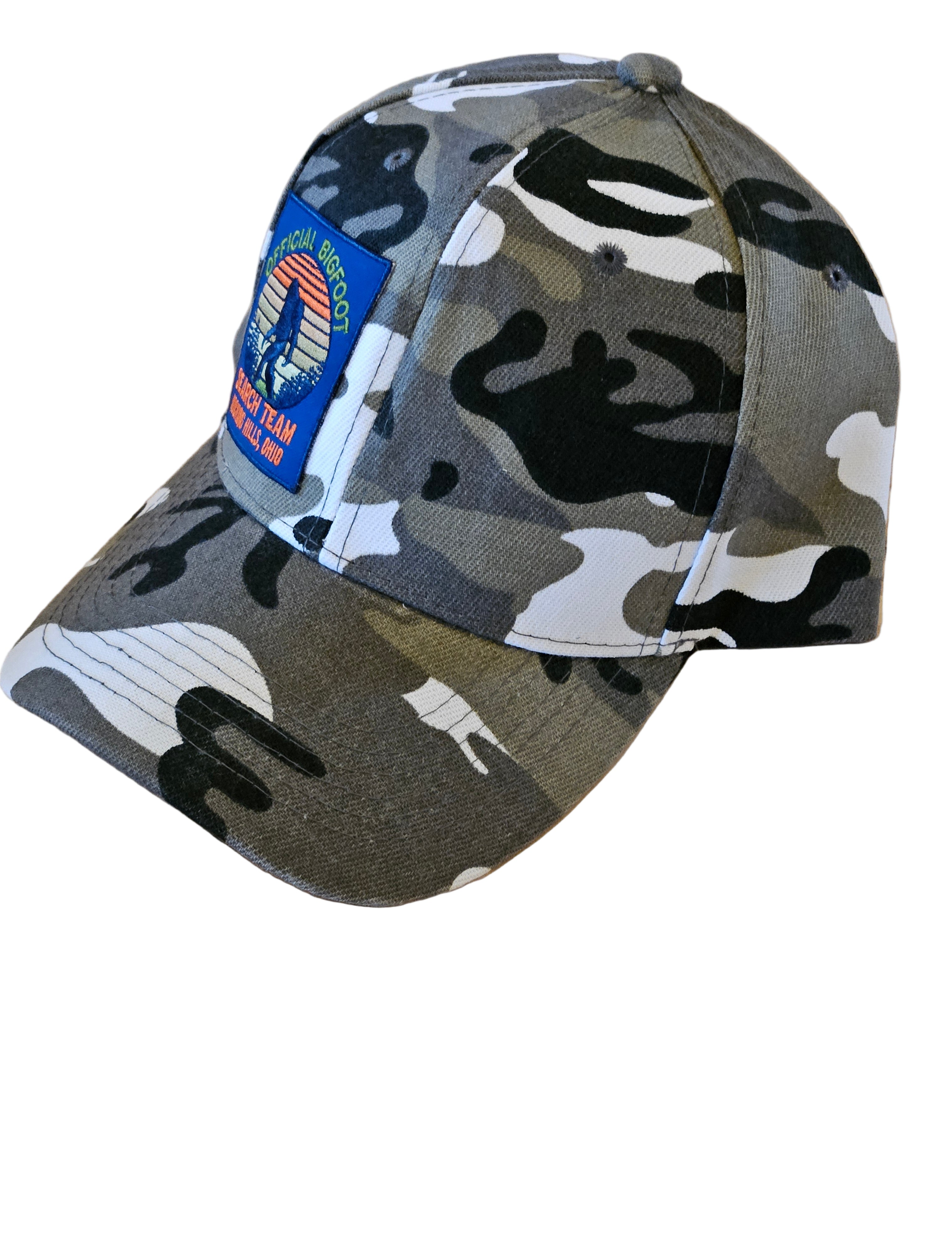 Camouflage-patterned cap with a patch on a wooden surface