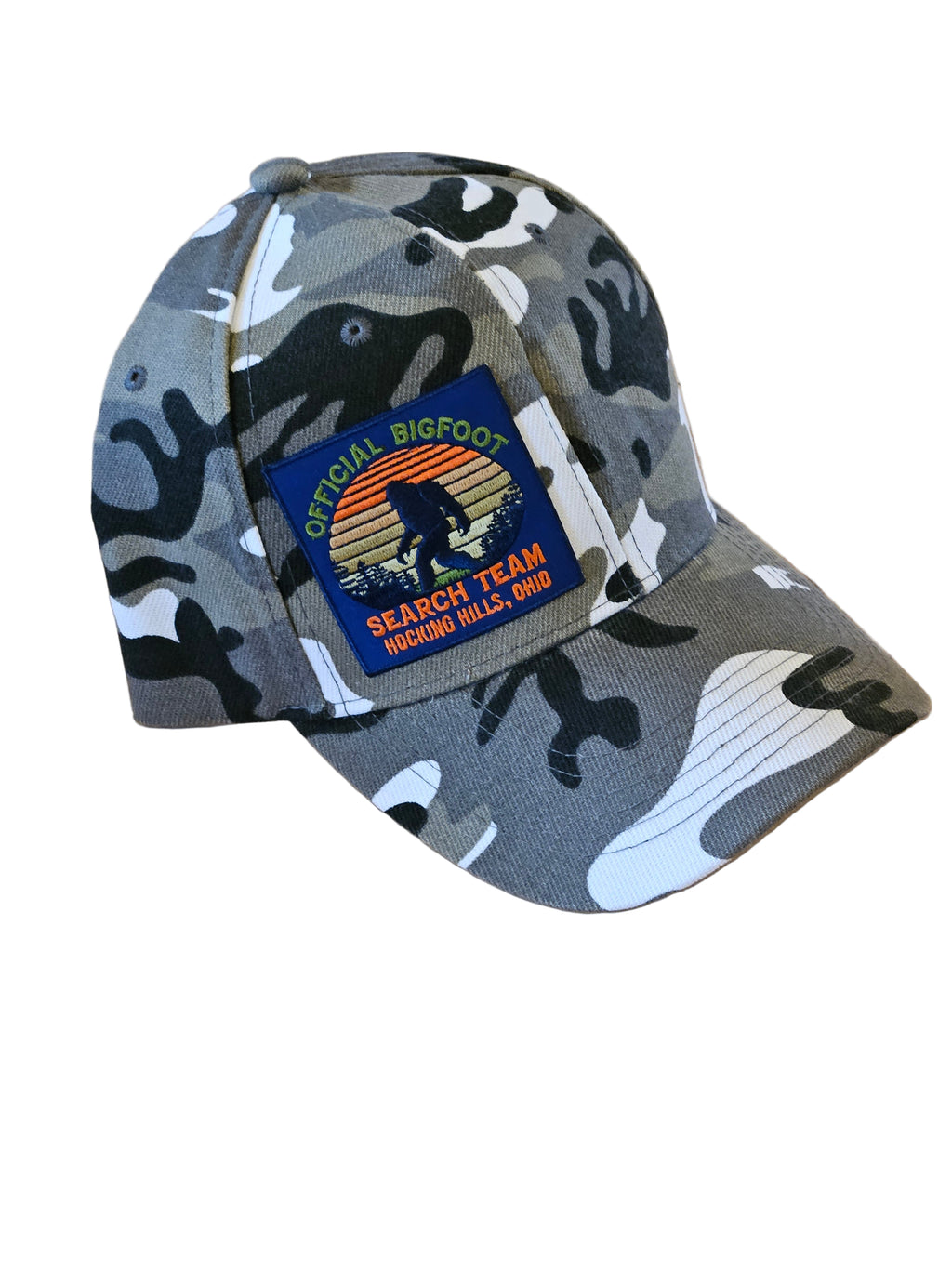 Camouflage-patterned cap with a patch on a wooden surface
