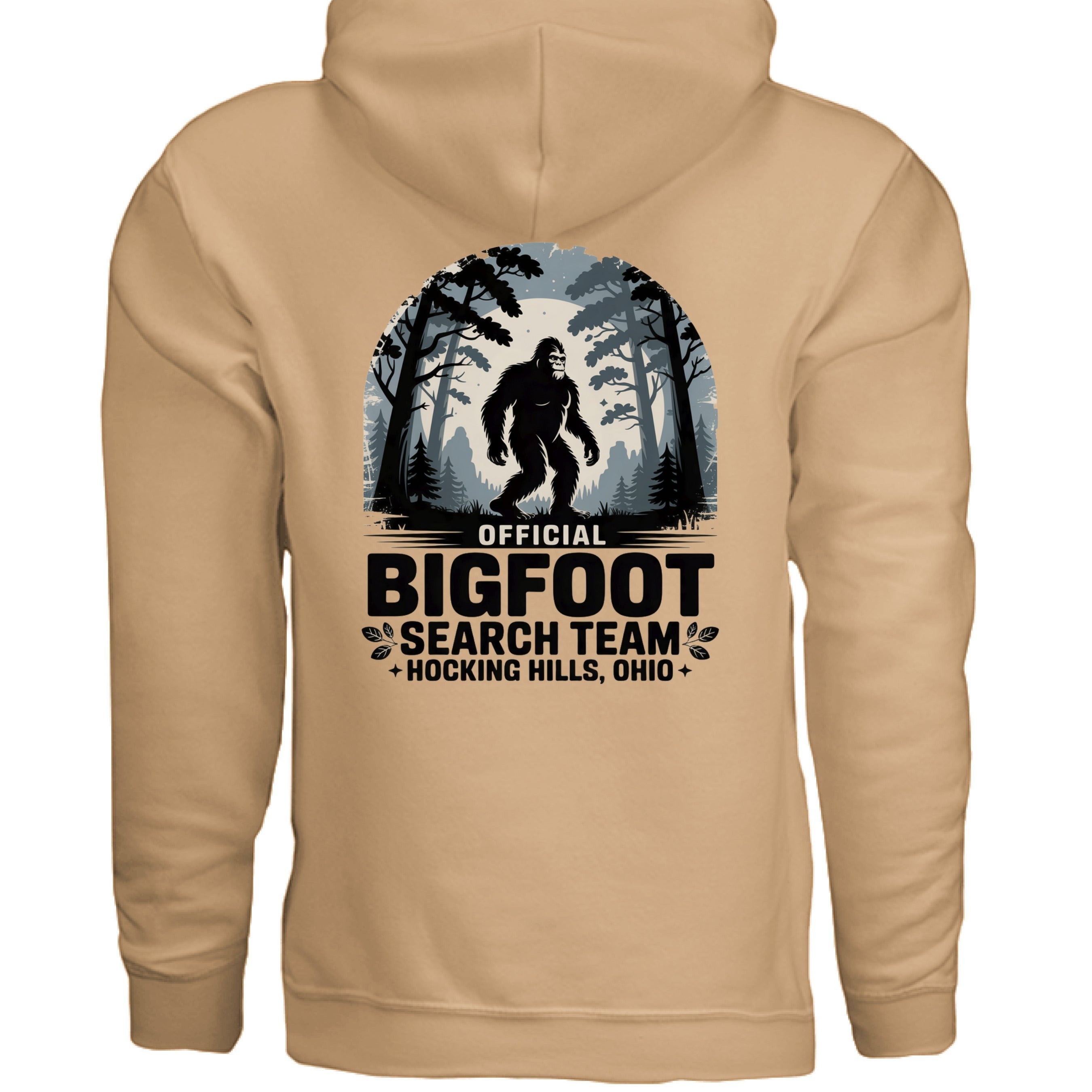 The Hocking Hills Store Official Bigfoot Search Team hoodie in tan, featuring a graphic of Bigfoot in a forest setting with text.