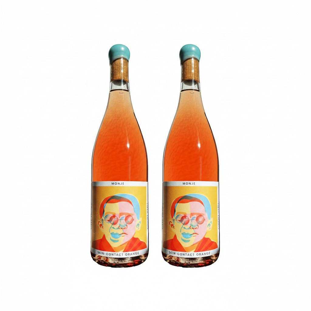 The Hocking Hills Store Monje 7-day skin-contact orange wine in clear bottles with colorful artistic labels.