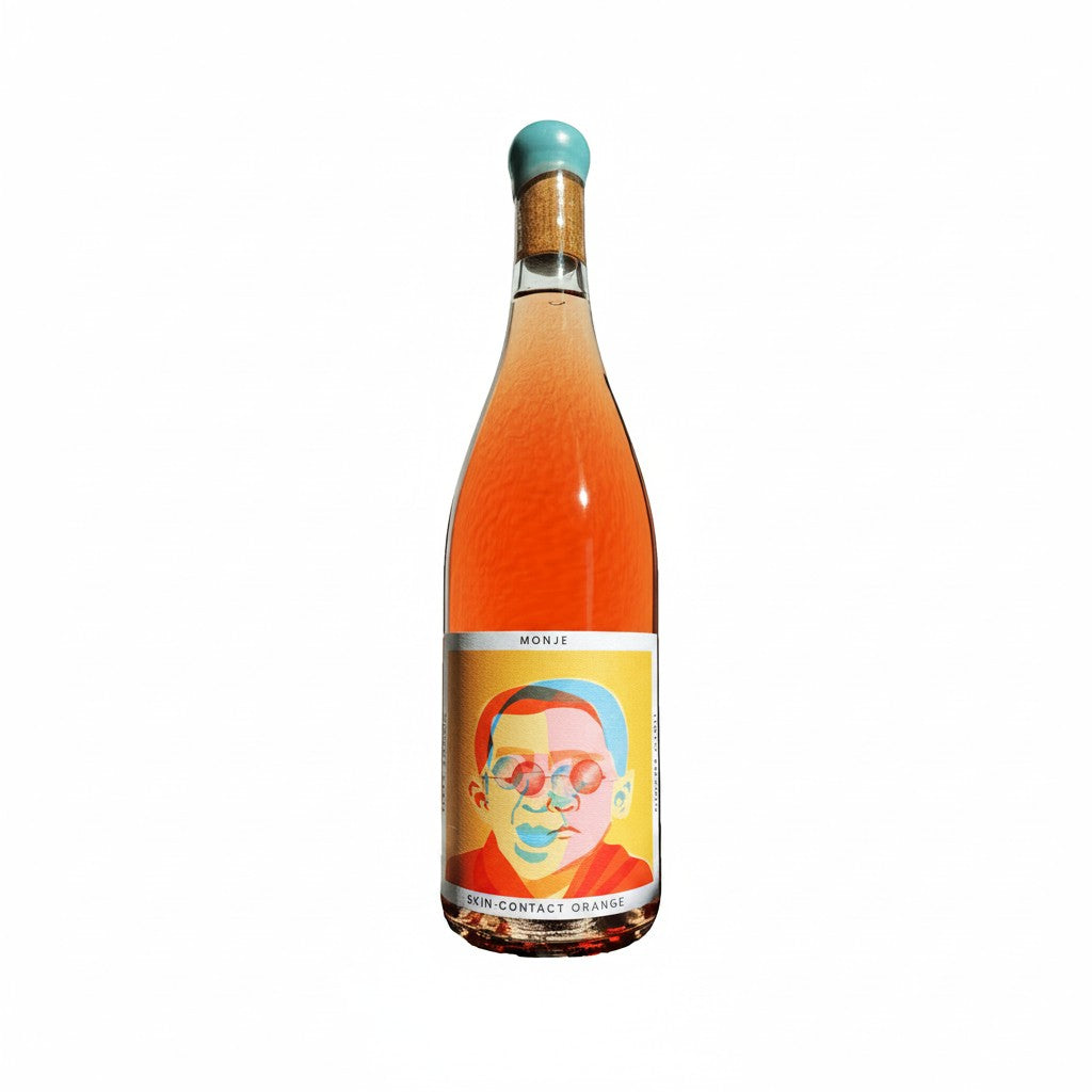 The Hocking Hills Store Monje orange wine bottle with a colorful abstract portrait label and a turquoise cap.