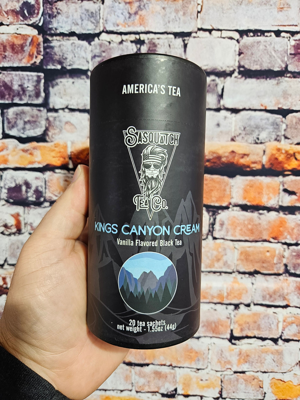 The Hocking Hills Store Sasquatch Tea Kings Canyon Cream vanilla-flavored black tea in a black cylinder with mountain graphics.