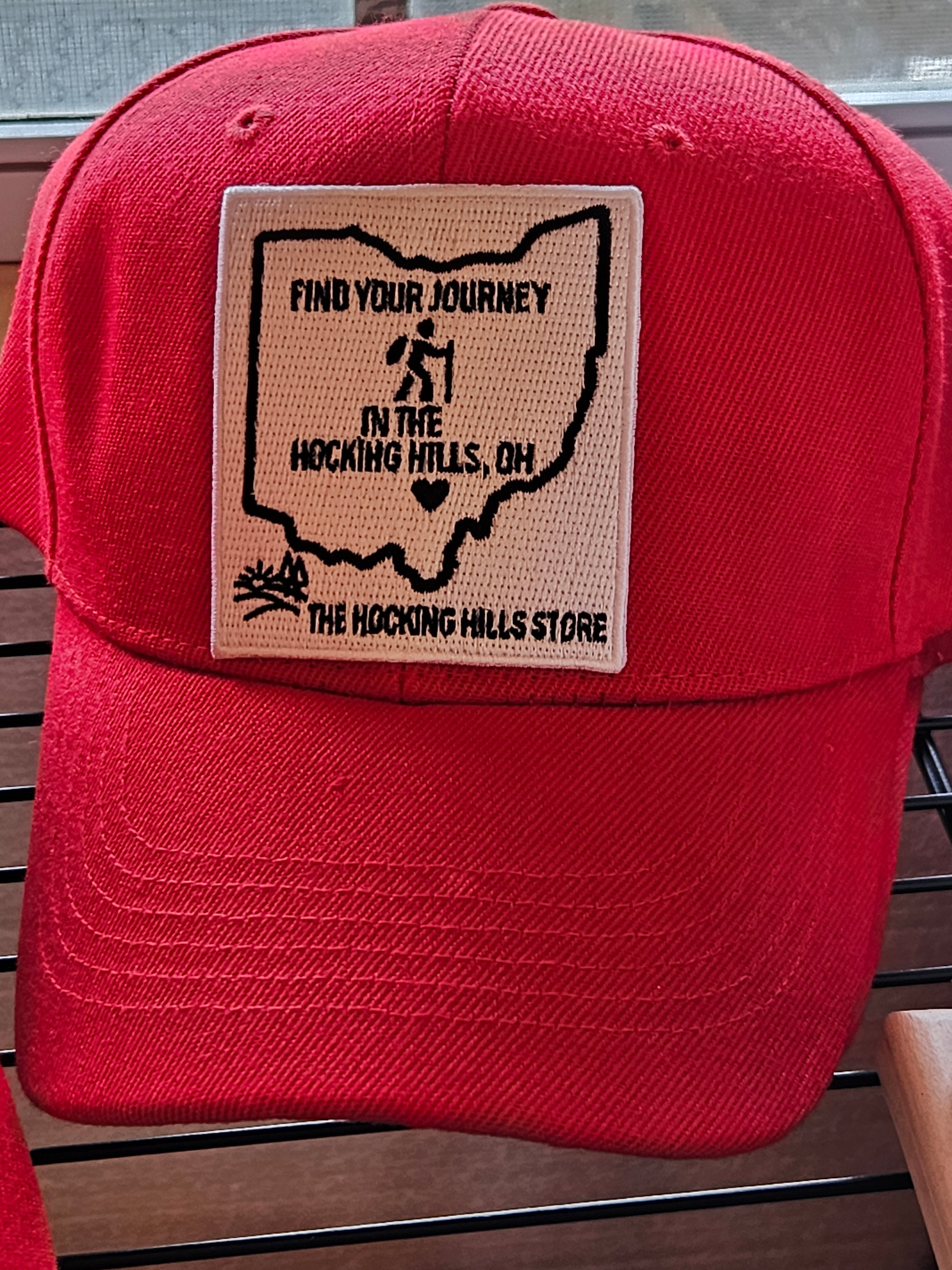 Red cap with a patch on a wooden surface