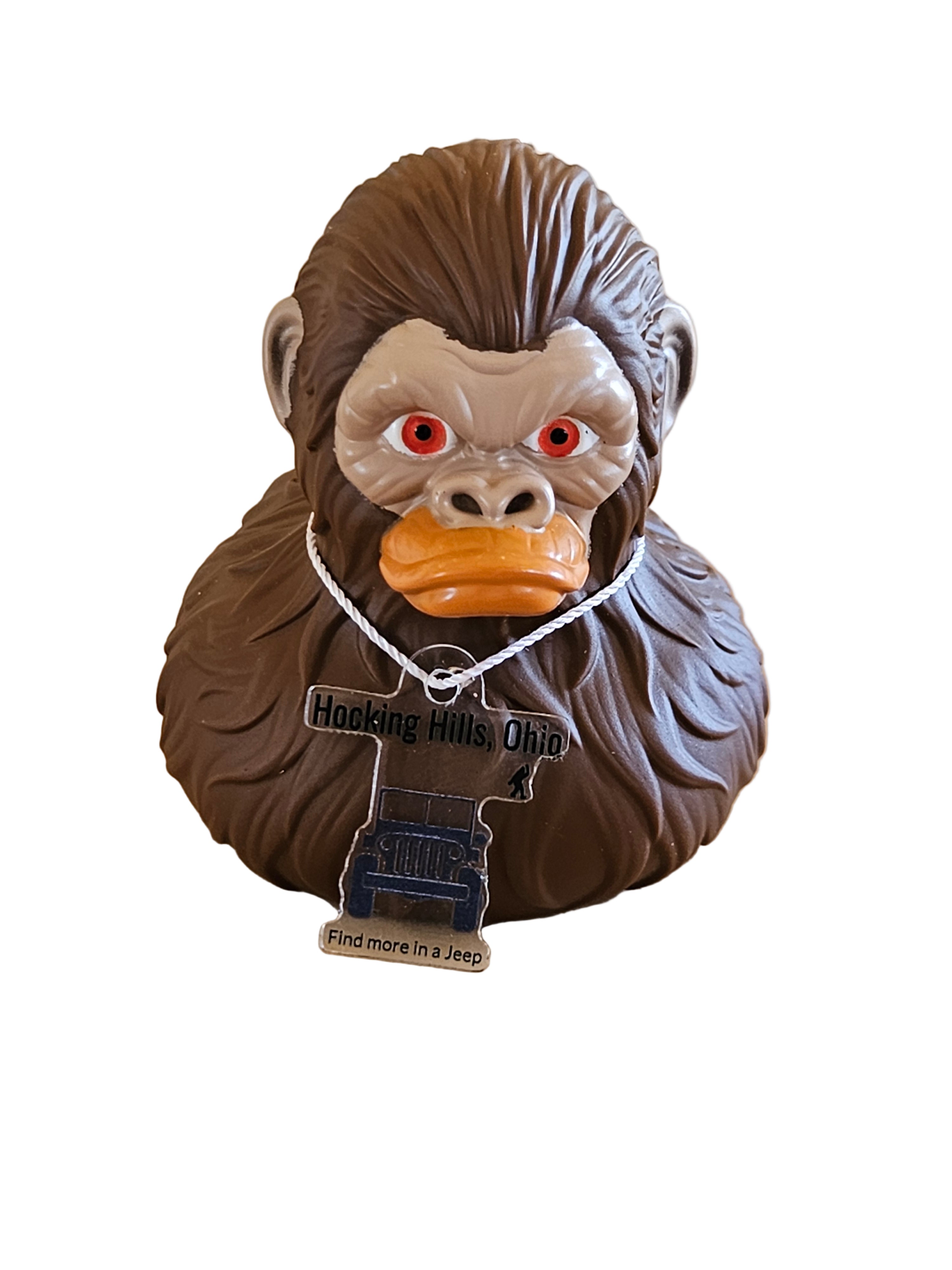 Decorative owl head with a tag on a wooden surface