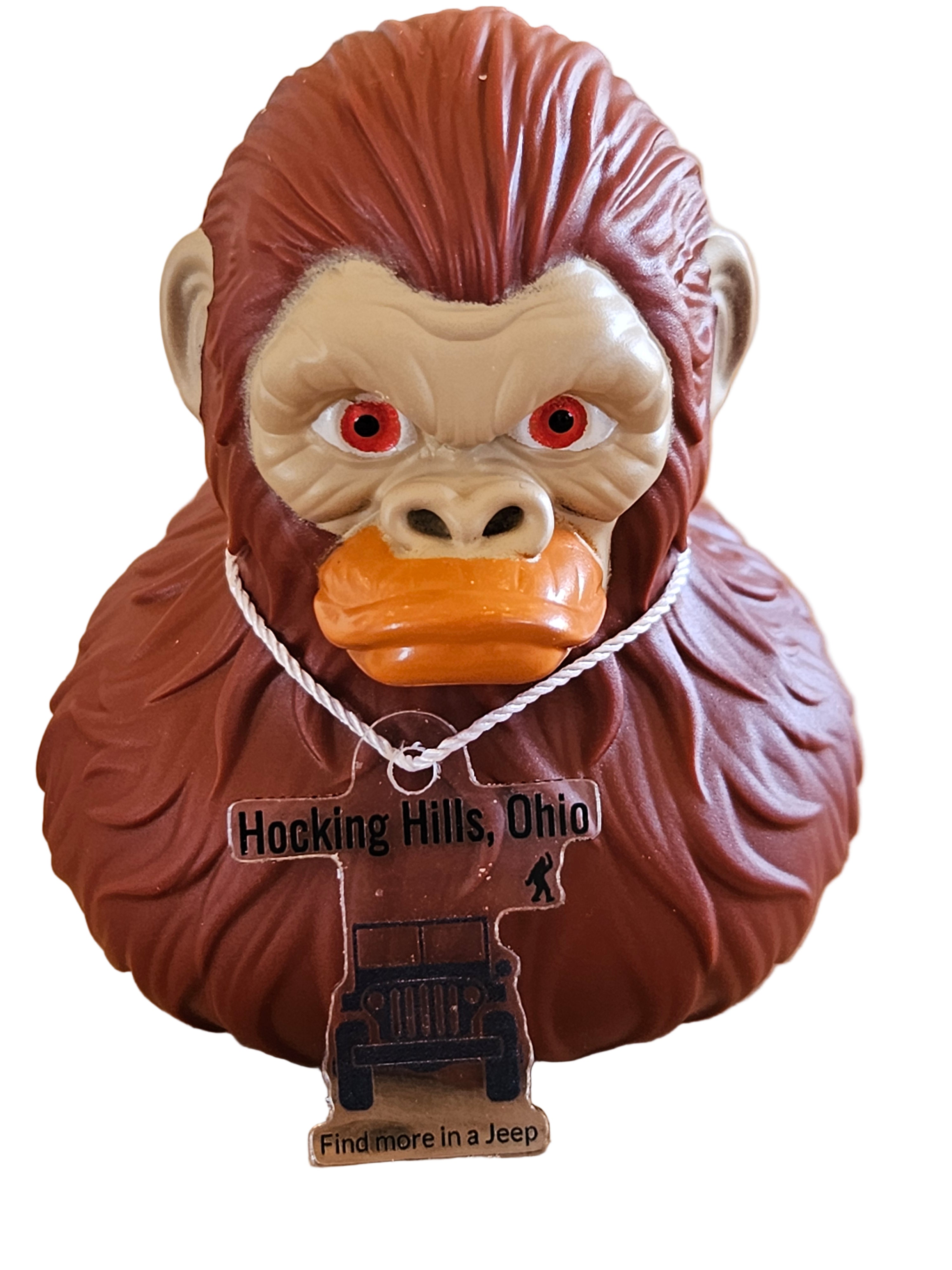 Decorative monkey head with a tag on a wooden background