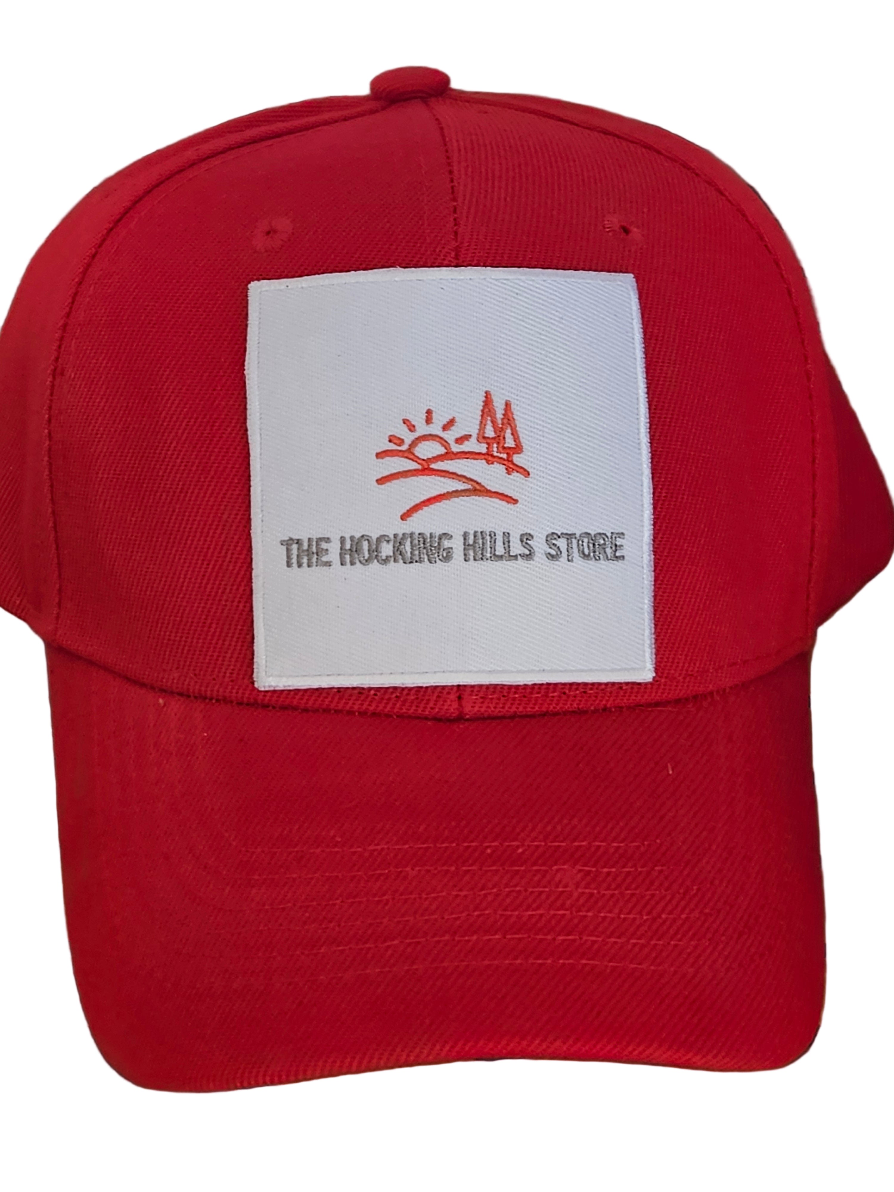 Red cap with a white label featuring a logo and text, placed on a black metal surface.