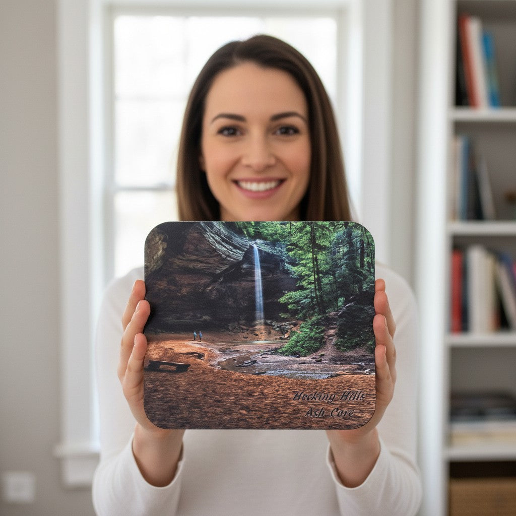 The Hocking Hills Store mouse pad featuring Ash Cave waterfall and lush green trees, with two people standing near the base.