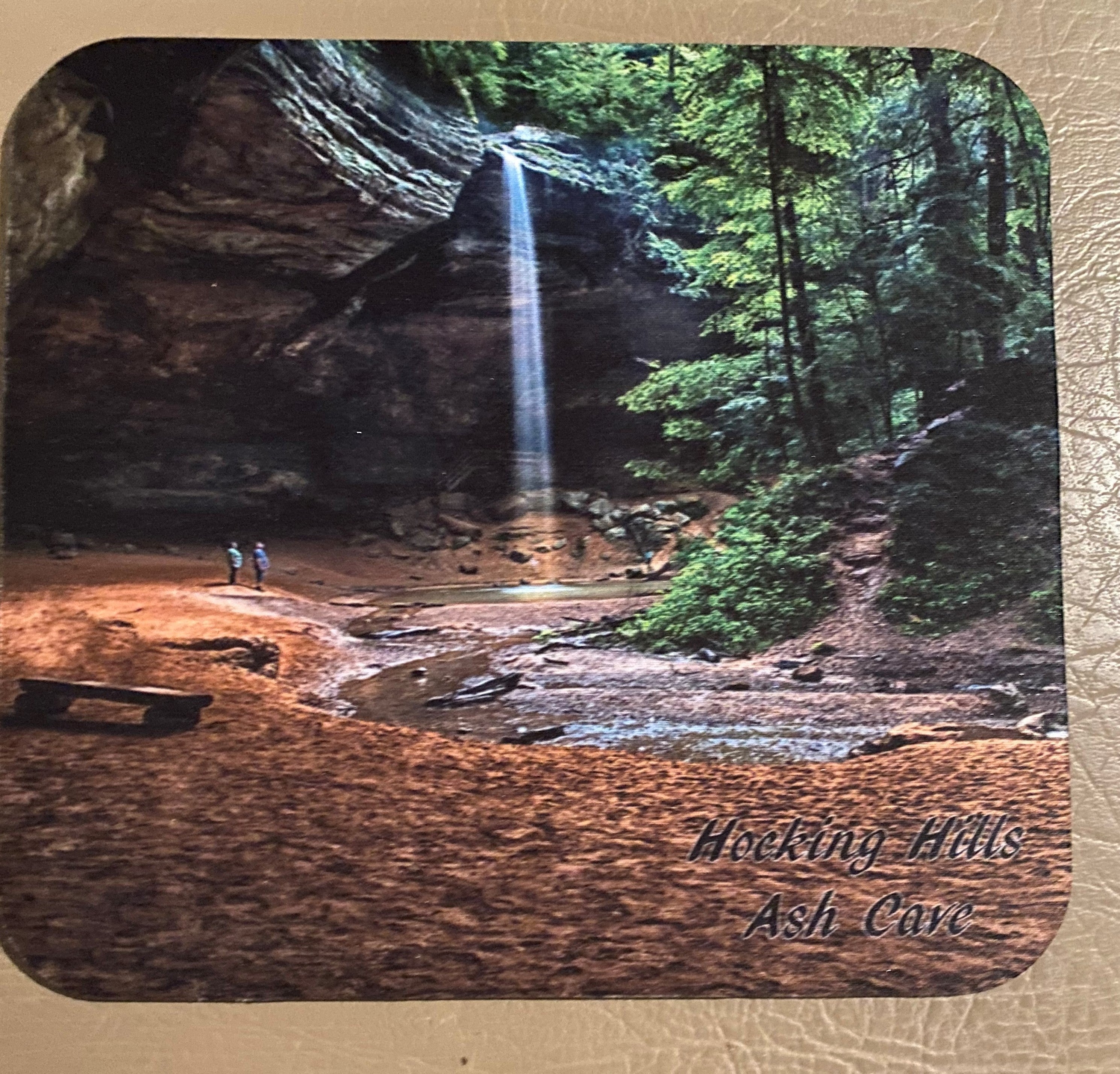 The Hocking Hills Store mouse pad featuring Ash Cave waterfall and lush green trees. Two people stand near the base of the falls.