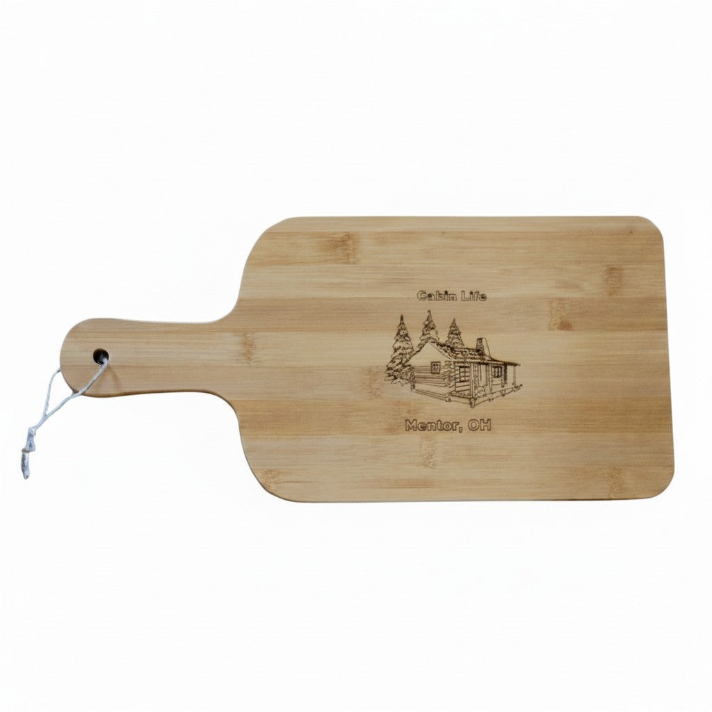 The Hocking Hills Store bamboo cutting board with laser engraved cabin and trees design, 15-inch.