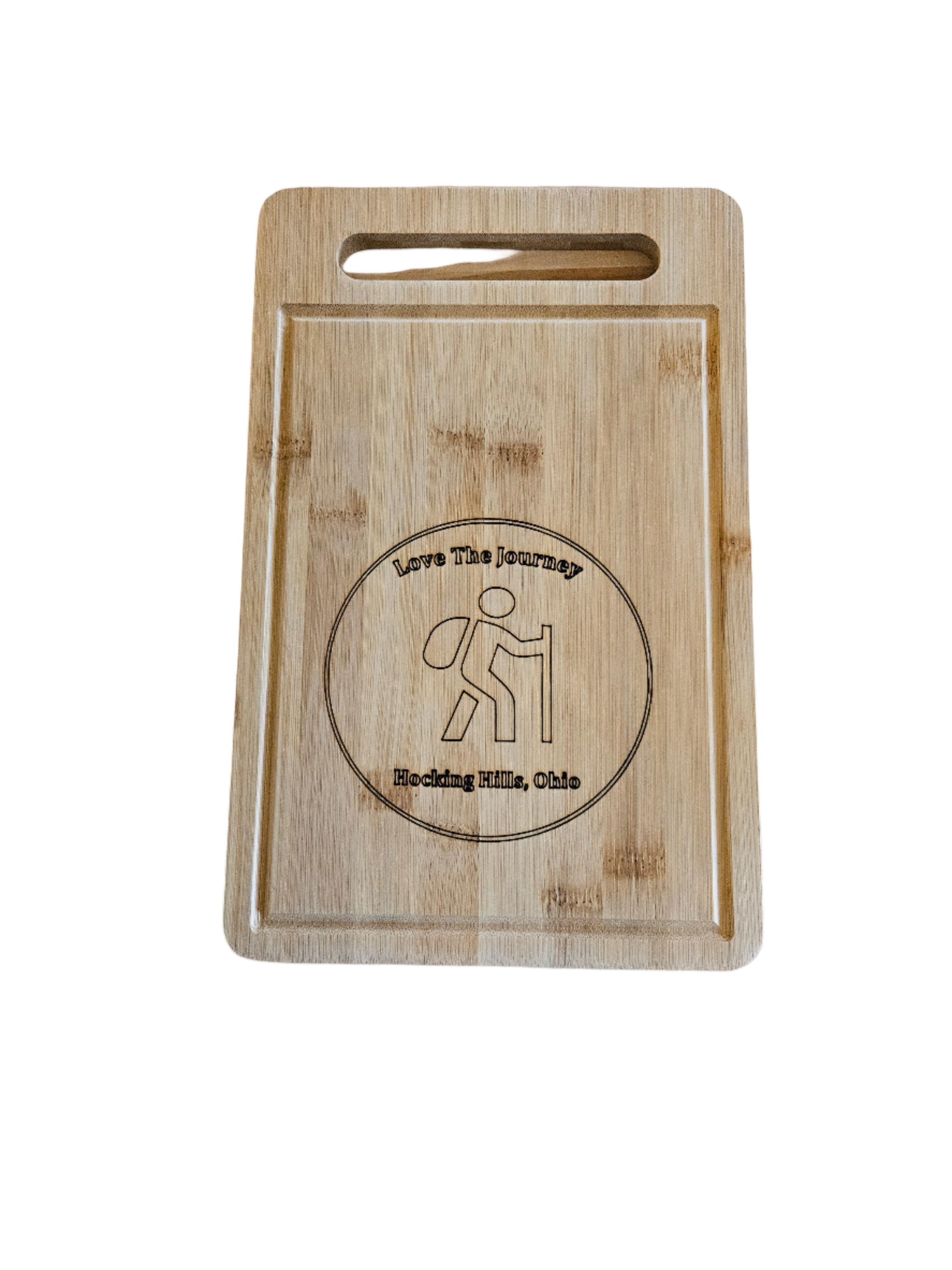 The Hocking Hills Store rectangle bamboo cutting board with engraved hiker graphic and