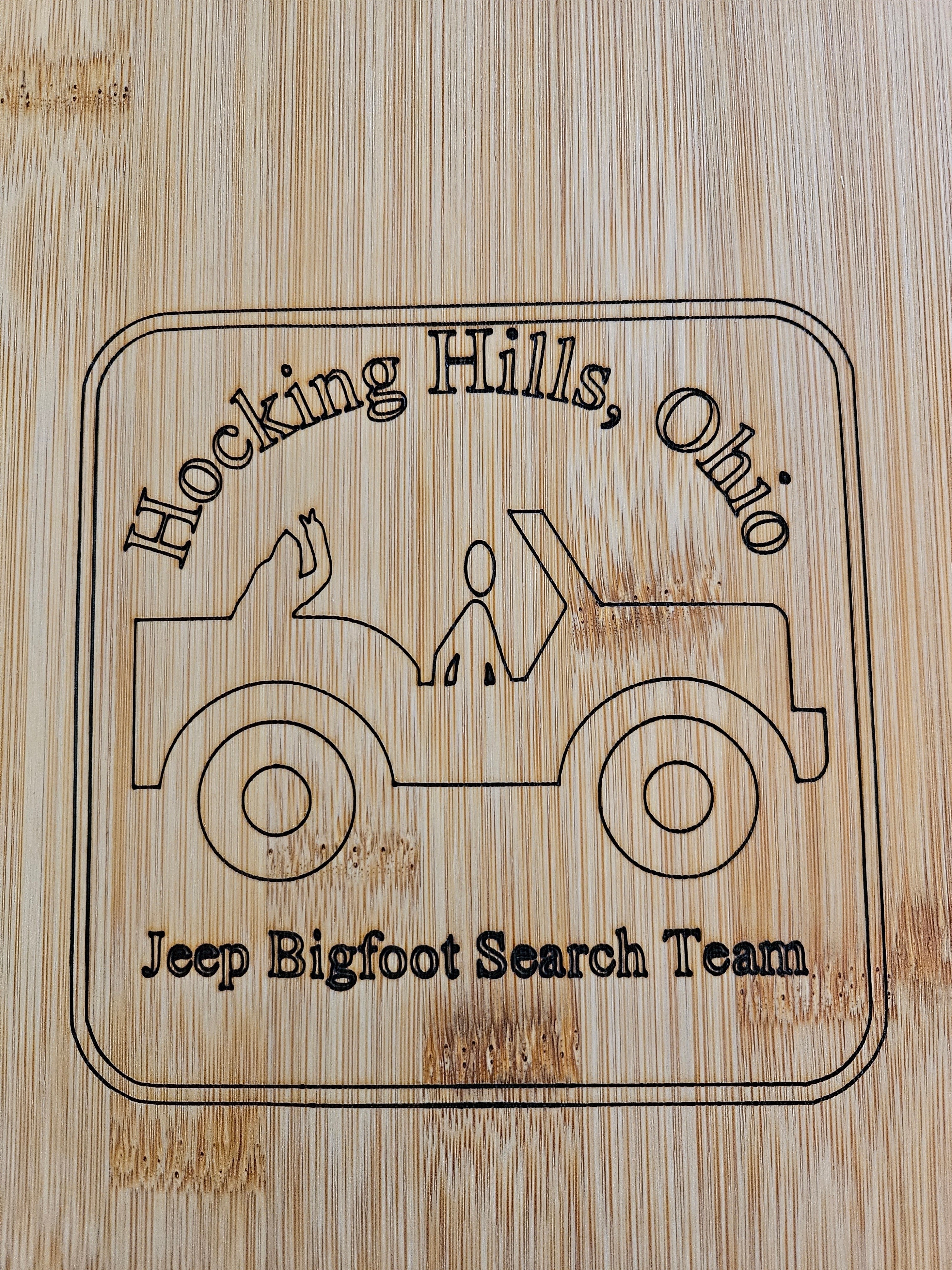 The Hocking Hills Store bamboo cutting board with a laser-etched design of a Jeep and the text "Hocking Hills, Ohio Jeep Bigfoot Search Team".