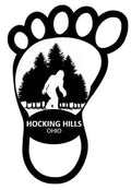 The Hocking Hills Store Bigfoot bumper sticker in a black foot shape with Bigfoot silhouette and trees inside.