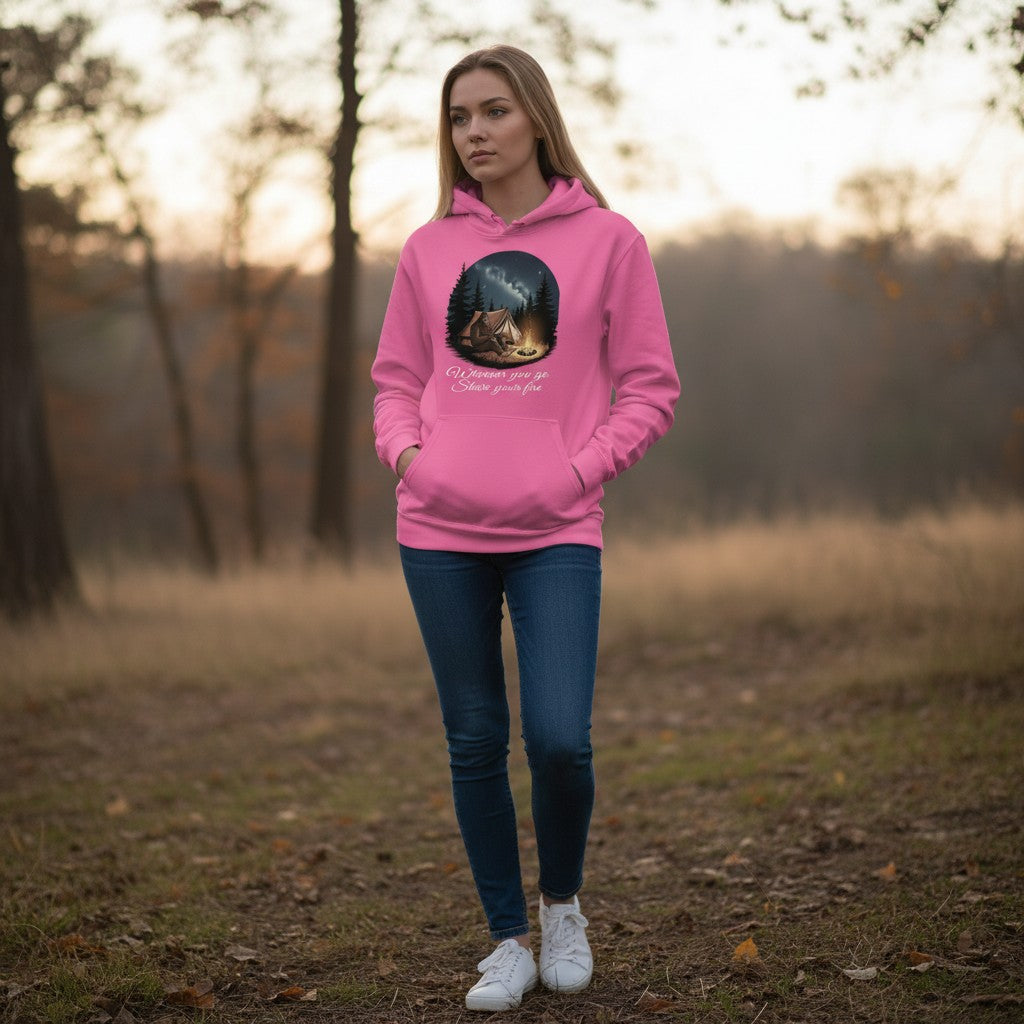 The Hocking Hills Store pink Bigfoot camping hoodie with graphic of Bigfoot by a campfire under starry sky.