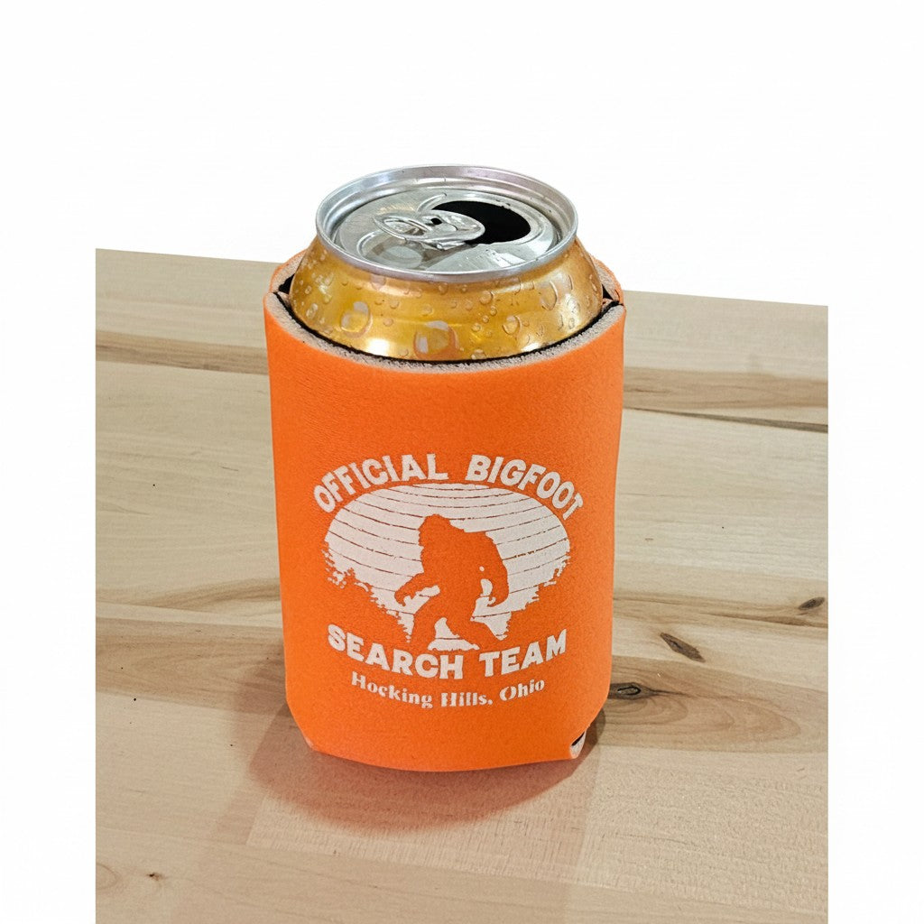 The Hocking Hills Store Official Bigfoot Search Team orange can cooler with a can inside. Features Bigfoot silhouette and text.