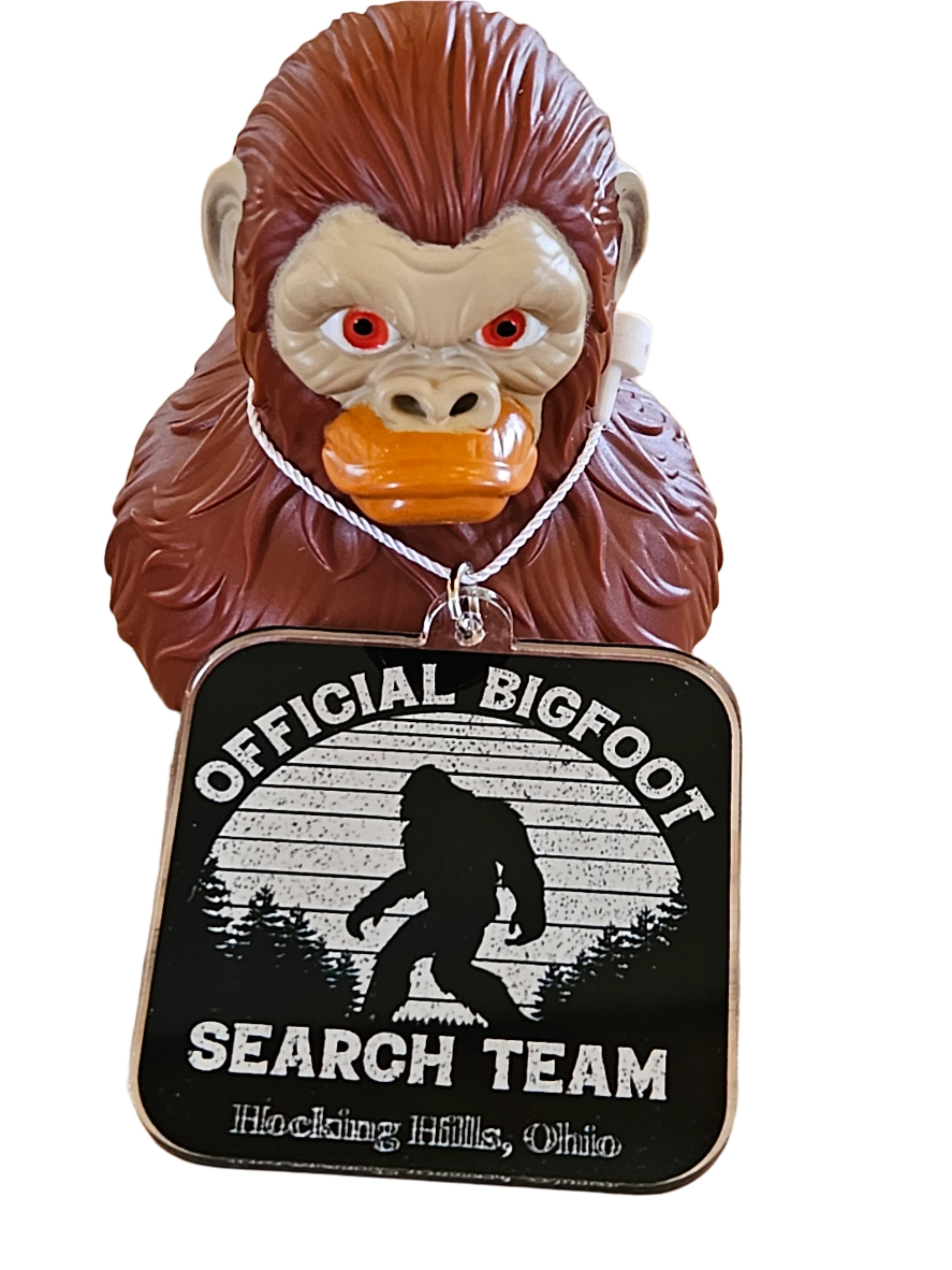 The Hocking Hills Store Bigfoot Jeep Duck with a Bigfoot Search Team tag, featuring a brown Bigfoot figure with red eyes and orange beak.