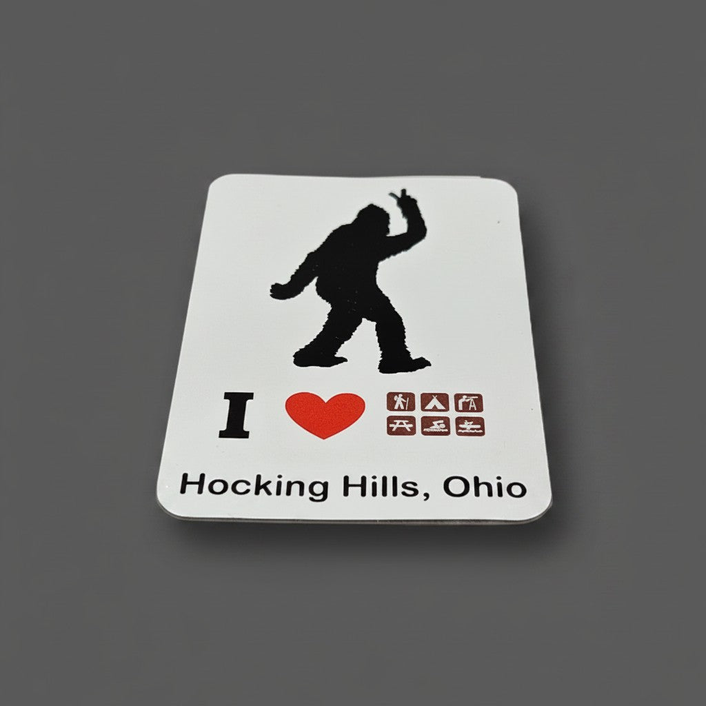 The Hocking Hills Store Bigfoot peace sign refrigerator magnet with I Love Hocking Hills, Ohio text and camping icons.