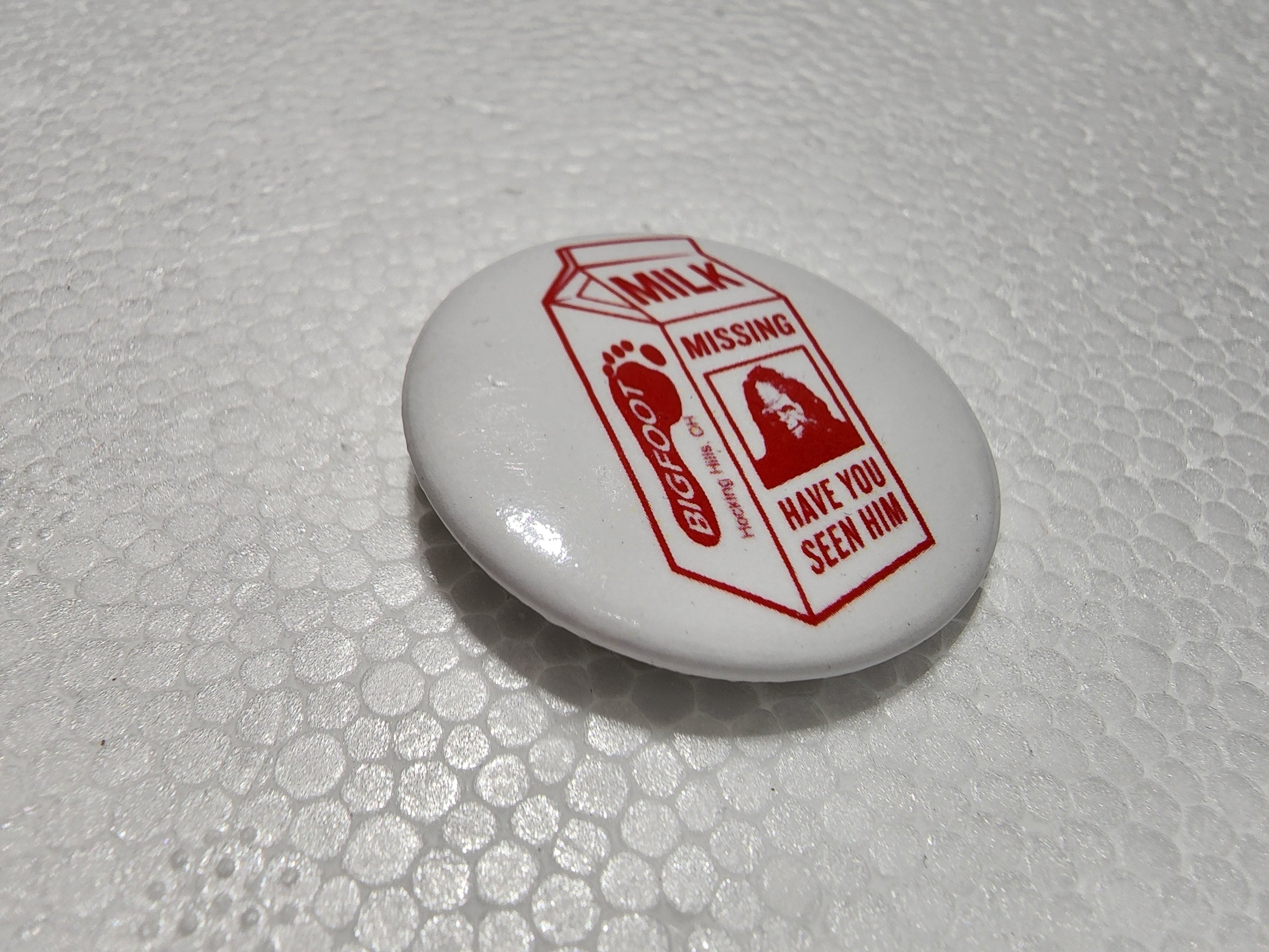 The Hocking Hills Store Big Foot milk carton button with red text and image of Bigfoot.