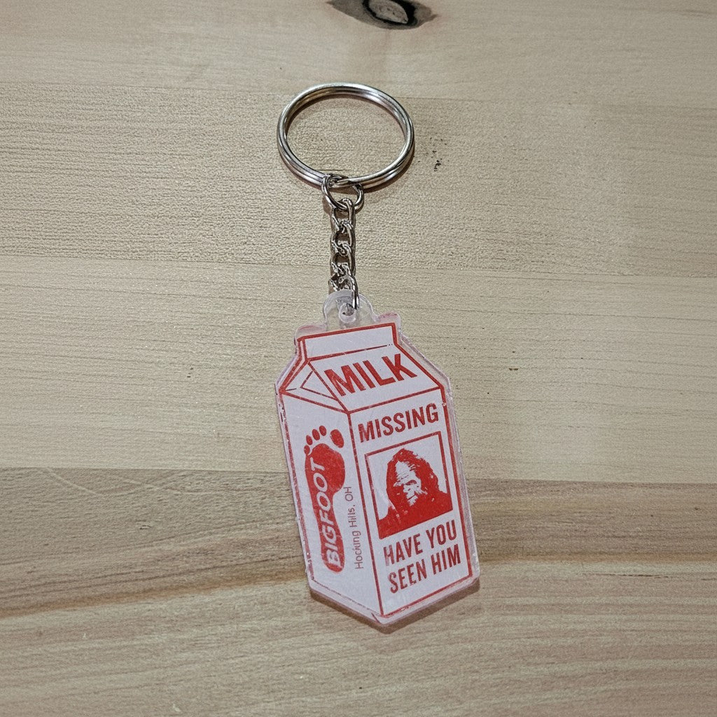 The Hocking Hills Store Bigfoot milk carton keychain with a red and white design. Features a Bigfoot footprint and a picture of Bigfoot with text.