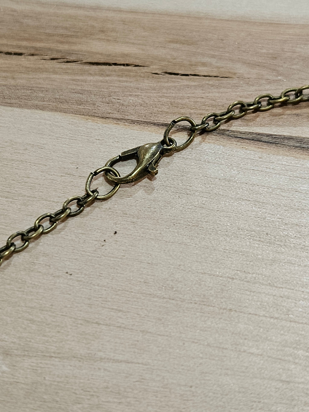 The Hocking Hills Store Bigfoot We Believe Pendant with antique brass chain and clasp.