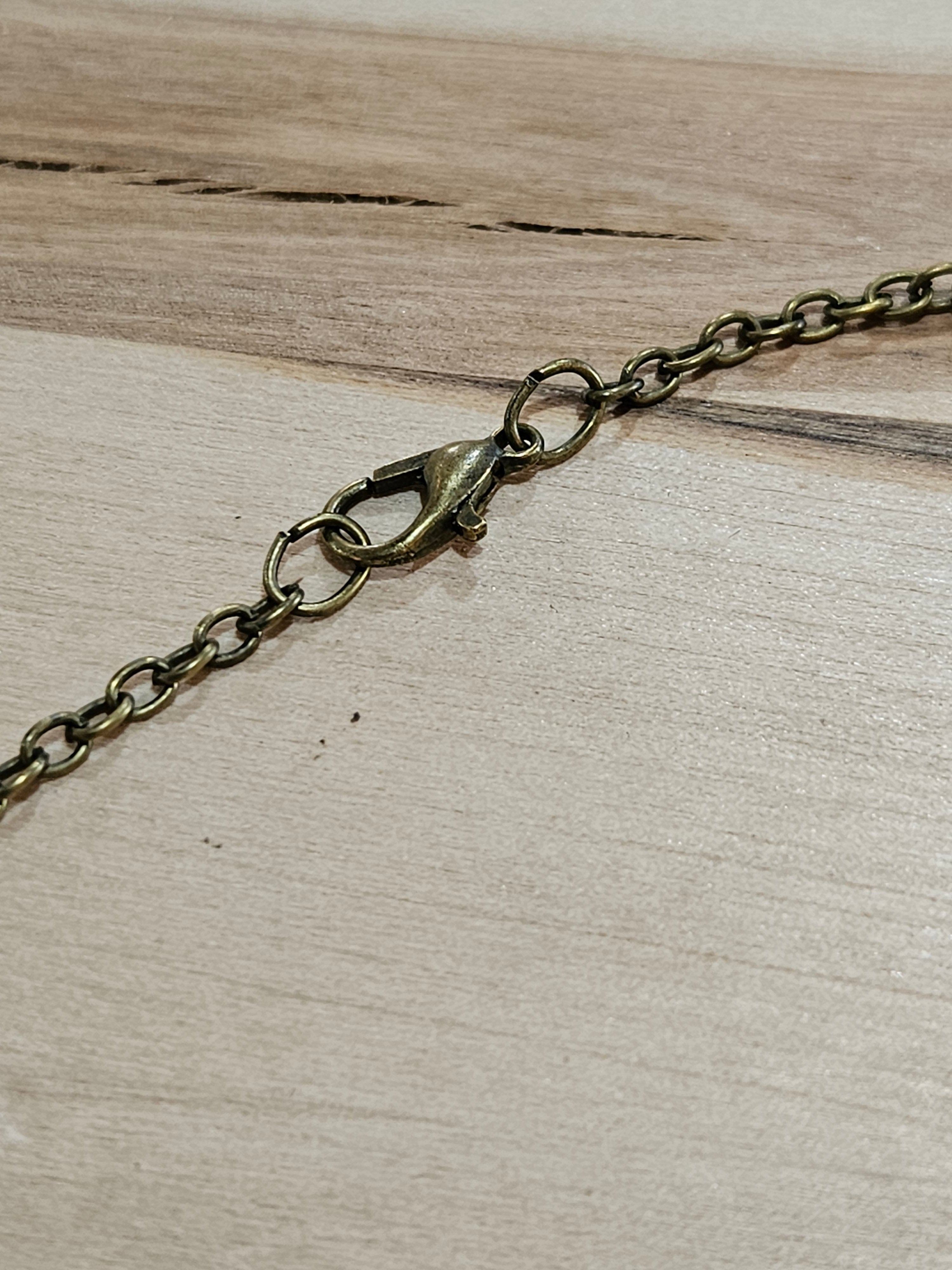 The Hocking Hills Store Bigfoot We Believe Pendant with antique brass chain and clasp.