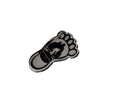 The Hocking Hills Store Bigfoot footprint pin, a silver-tone metal pin with a black Bigfoot silhouette and Hocking Hills, Ohio text.
