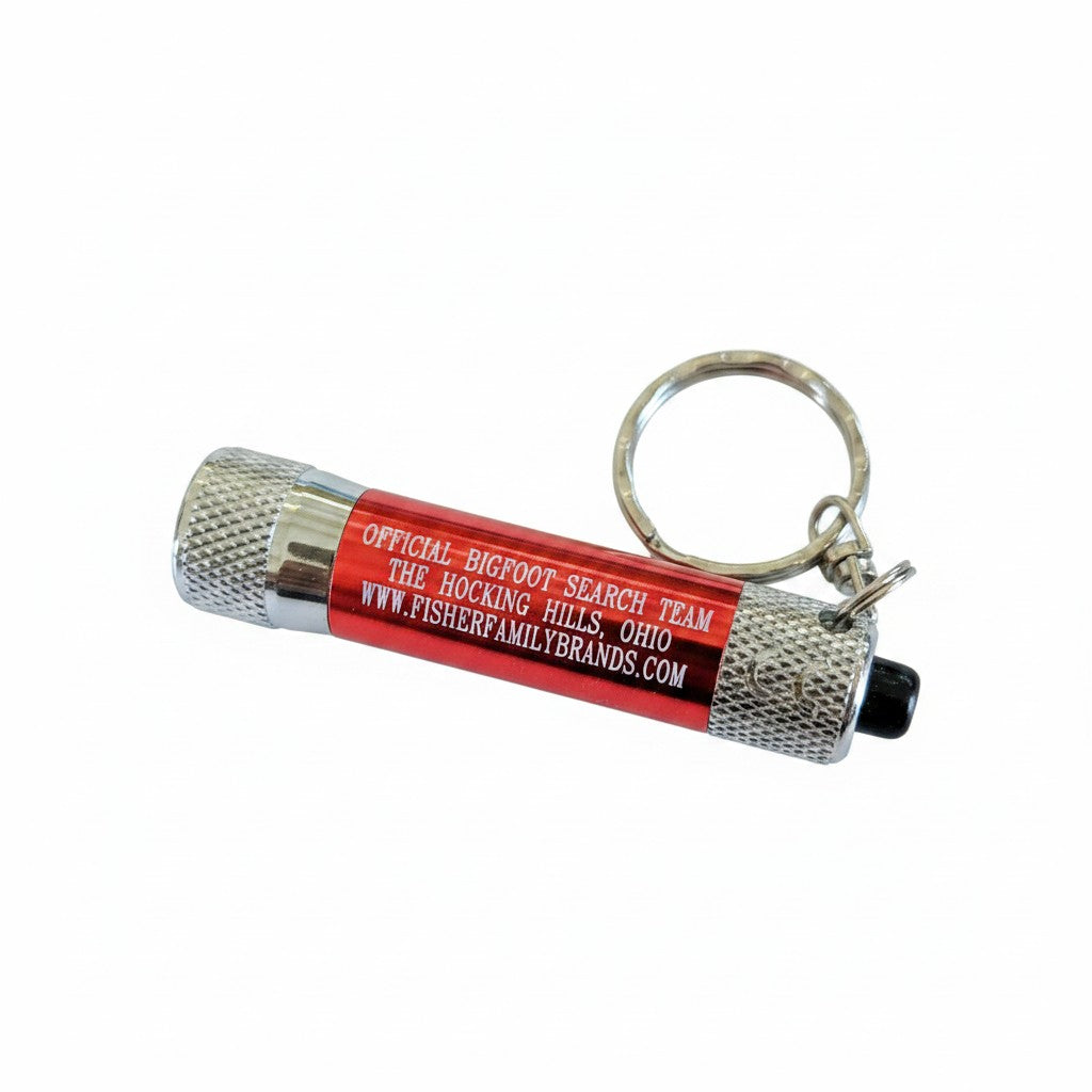 The Hocking Hills Store red metal Bigfoot Search Team keychain flashlight with silver keyring.