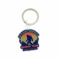 The Hocking Hills Store Official Bigfoot Search Team keychain features a silhouette of Bigfoot against a sunset and forest landscape.