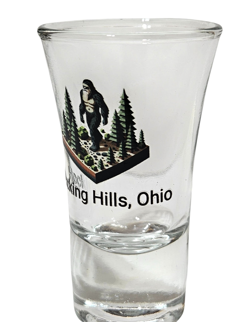 The Hocking Hills Store Bigfoot shot glass features a Bigfoot graphic with pine trees and text reading "Hocking Hills, Ohio".