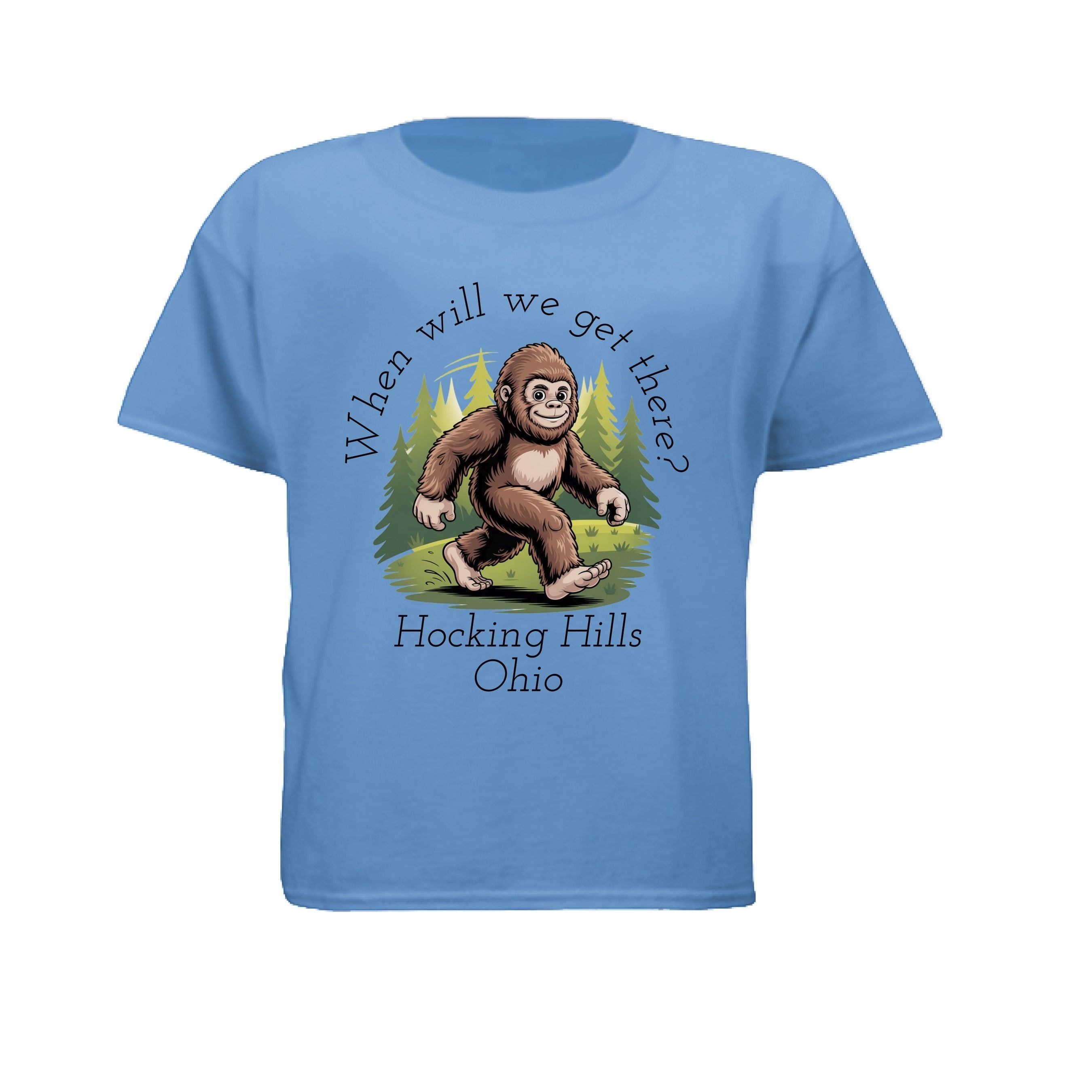 The Hocking Hills Store blue Bigfoot t-shirt for kids with a graphic of Bigfoot walking through trees and the text "When Will We Get There? Hocking Hills Ohio."