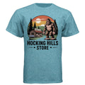 The Hocking Hills Store Bigfoot T-Shirt in heathered blue tri-blend fabric, featuring a graphic of Bigfoot standing outside a country store.